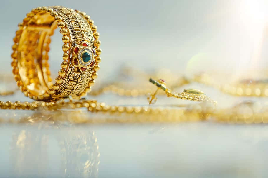 gold jewelry, intricate beadwork, central blue gemstone, SD Desktop Wallpaper