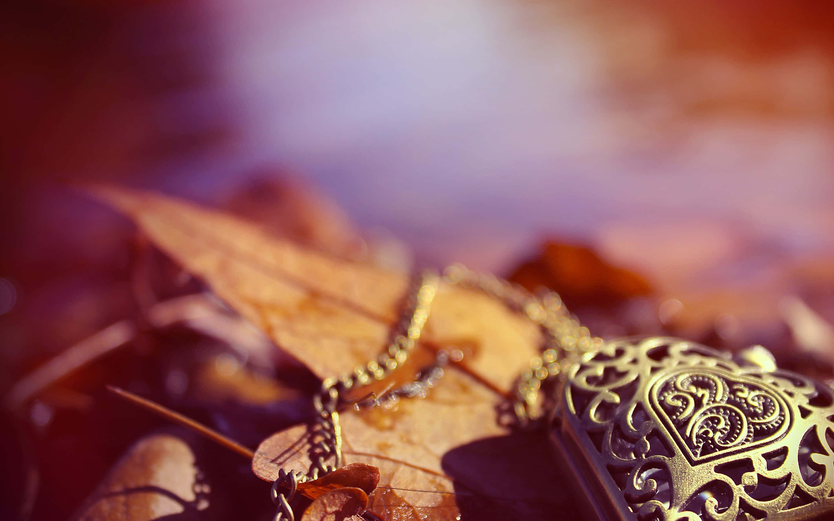 Golden ornate locket, chain, autumn leaves, 2K Desktop Wallpaper