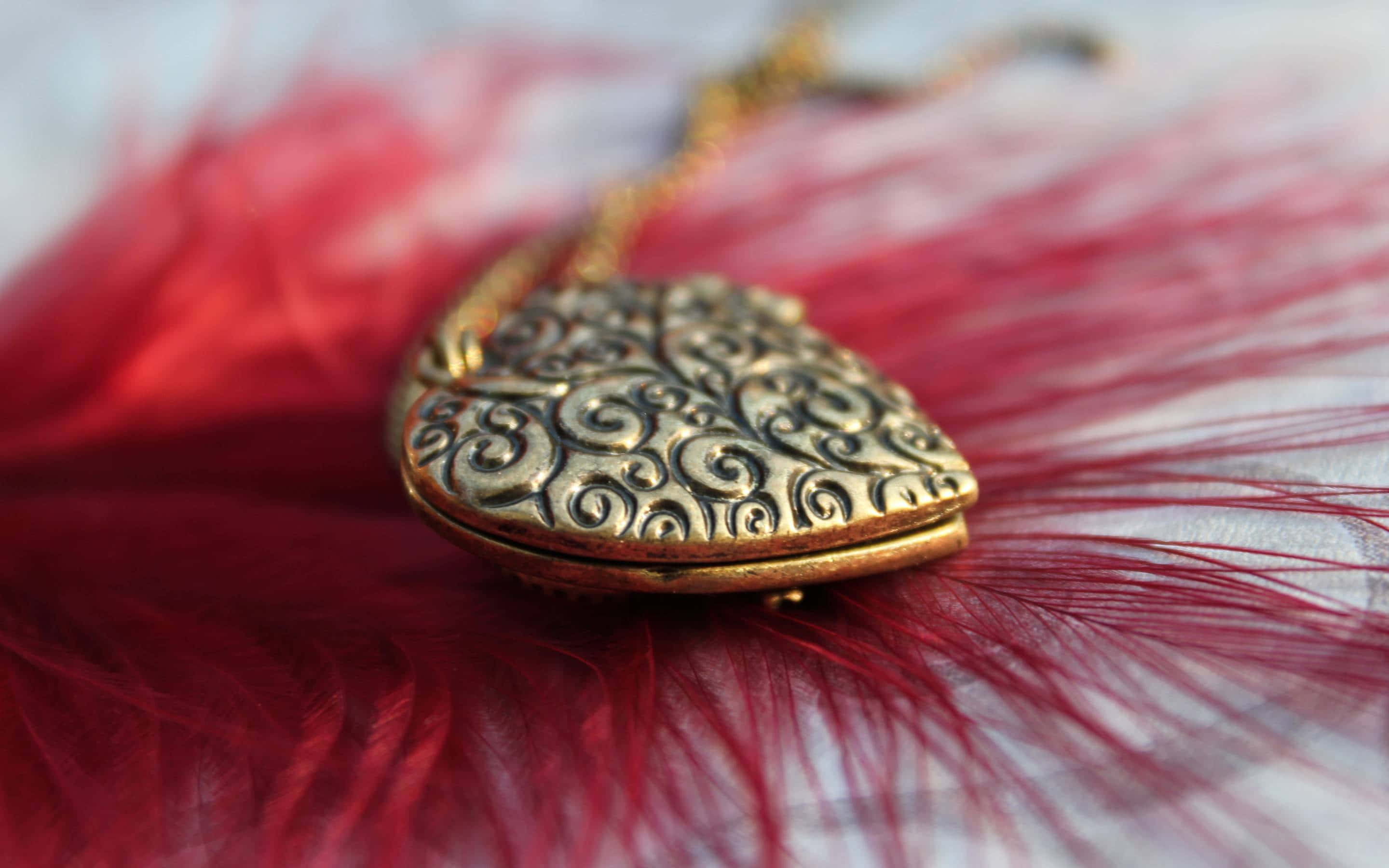 gold locket, swirling filigree, vibrant red feather, 2K Desktop Wallpaper