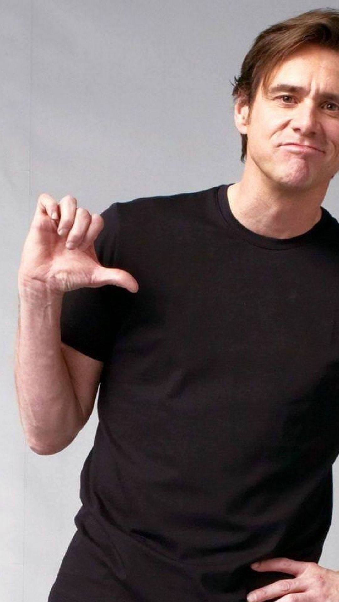 Jim Carrey, black t-shirt, playful hand gesture, Full HD Phone Wallpaper