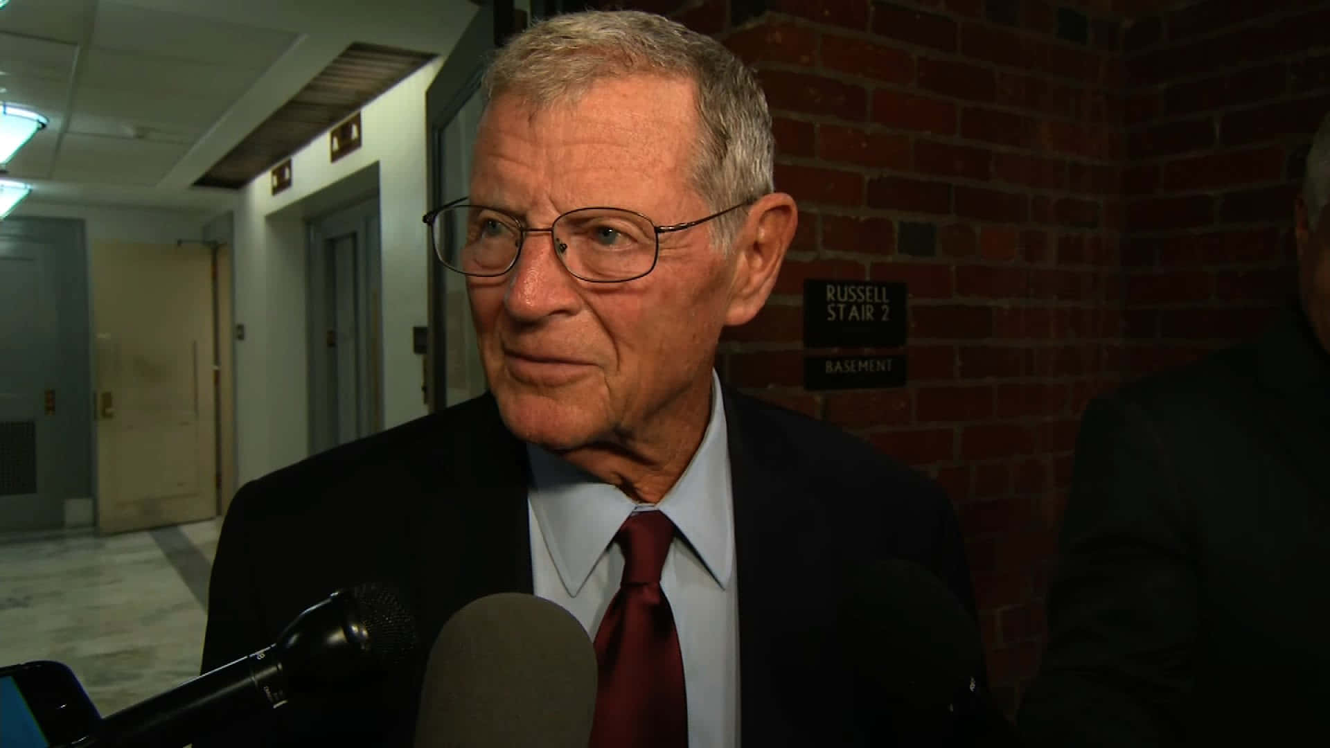 Jim Inhofe, two microphones, dimly lit hallway, Full HD Desktop Wallpaper
