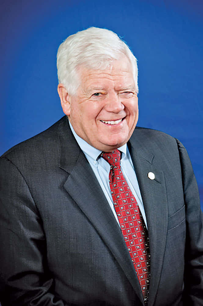Jim Mcdermott, blue studio background, dark suit, SD Phone Wallpaper