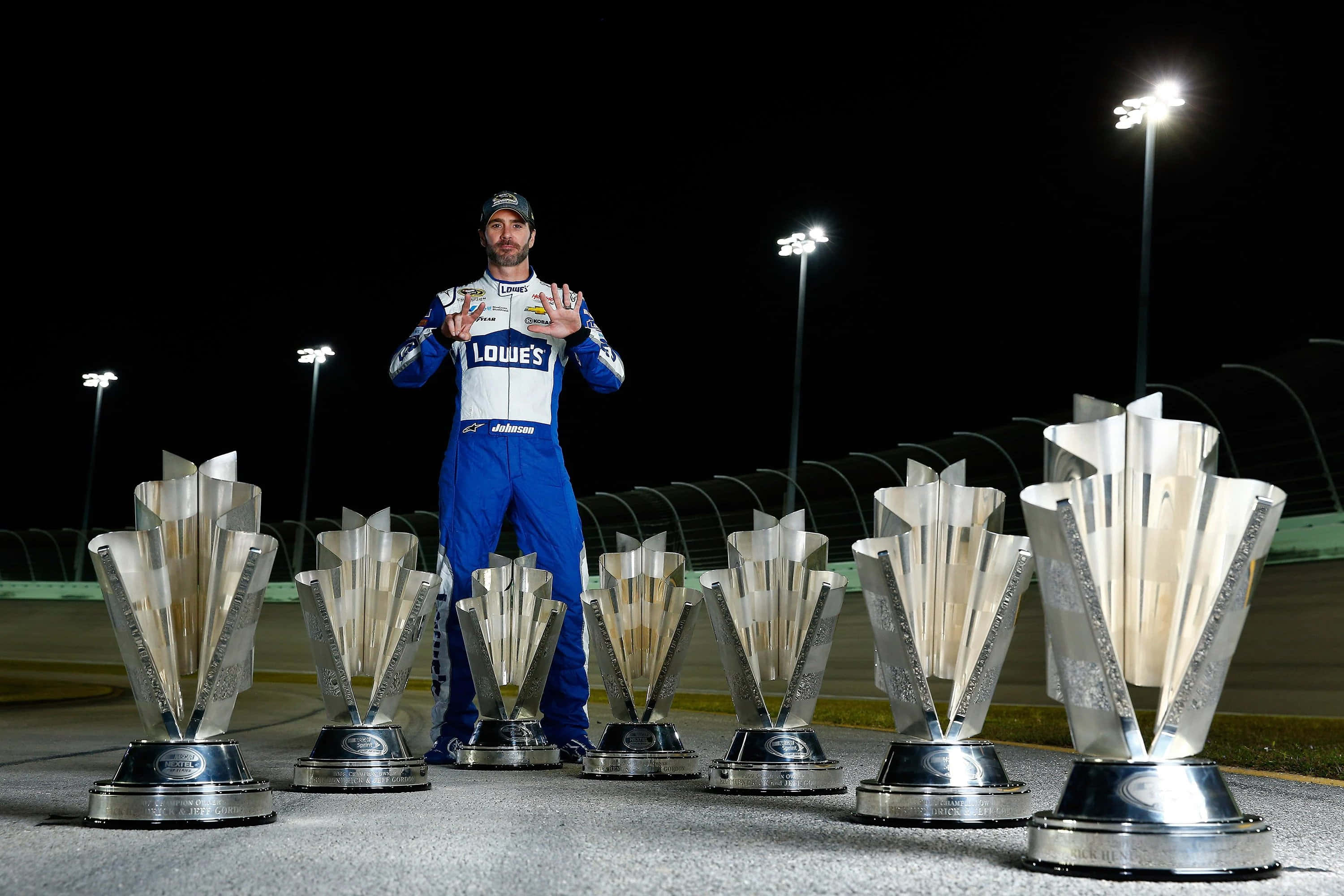 Jimmie Johnson, blue Lowe's uniform, seven gleaming silver trophies, 2K Desktop Wallpaper