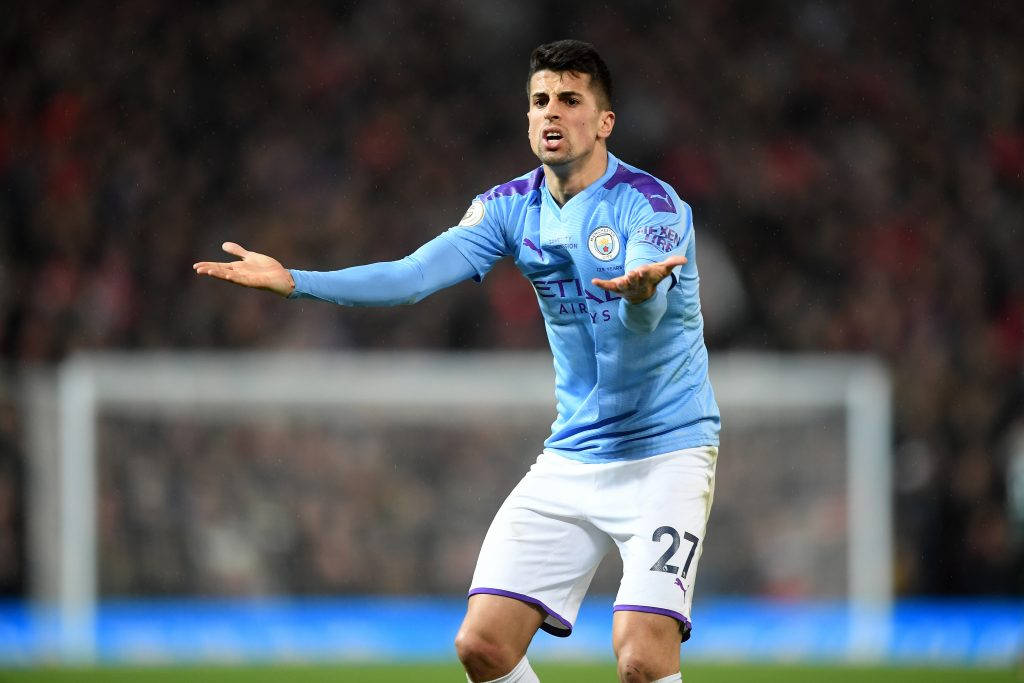 Joao Cancelo, light blue jersey, rain-slicked pitch, SD Desktop Wallpaper