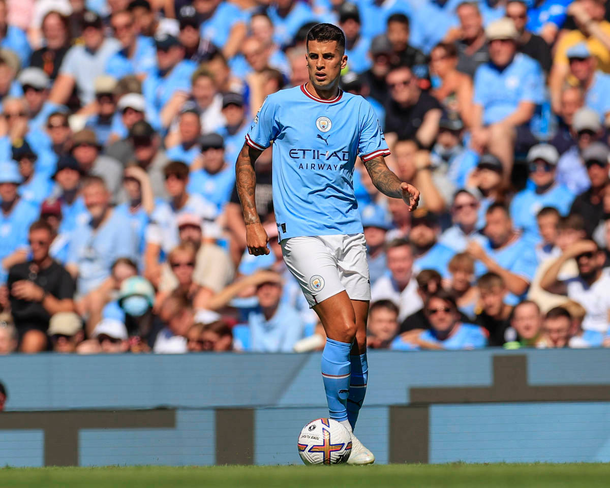 Joao Cancelo, light blue jersey, sunlit pitch, SD Desktop Wallpaper