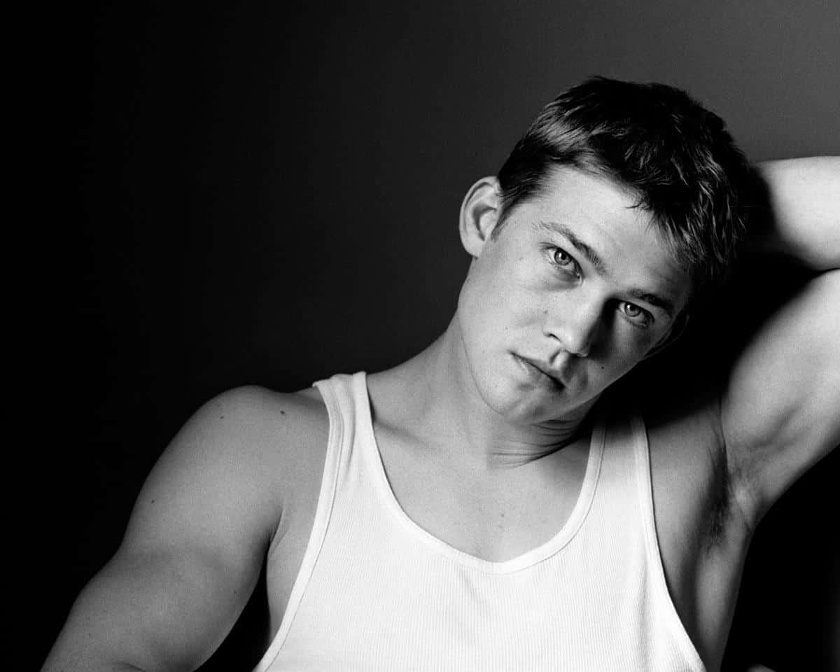 Joe Alwyn, white tank top, dark background, SD Desktop Wallpaper
