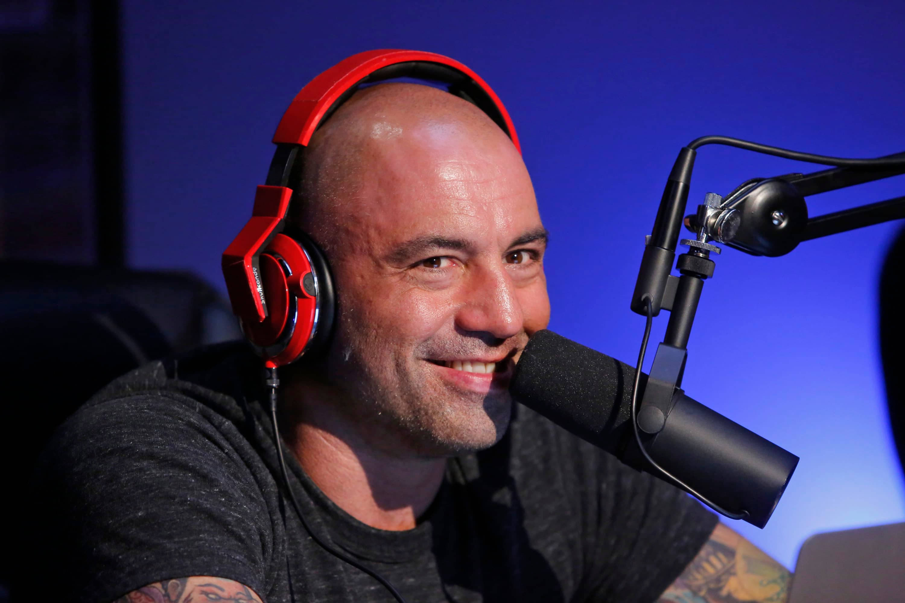 Joe Rogan, red headphones, studio microphone, 2K Desktop Wallpaper