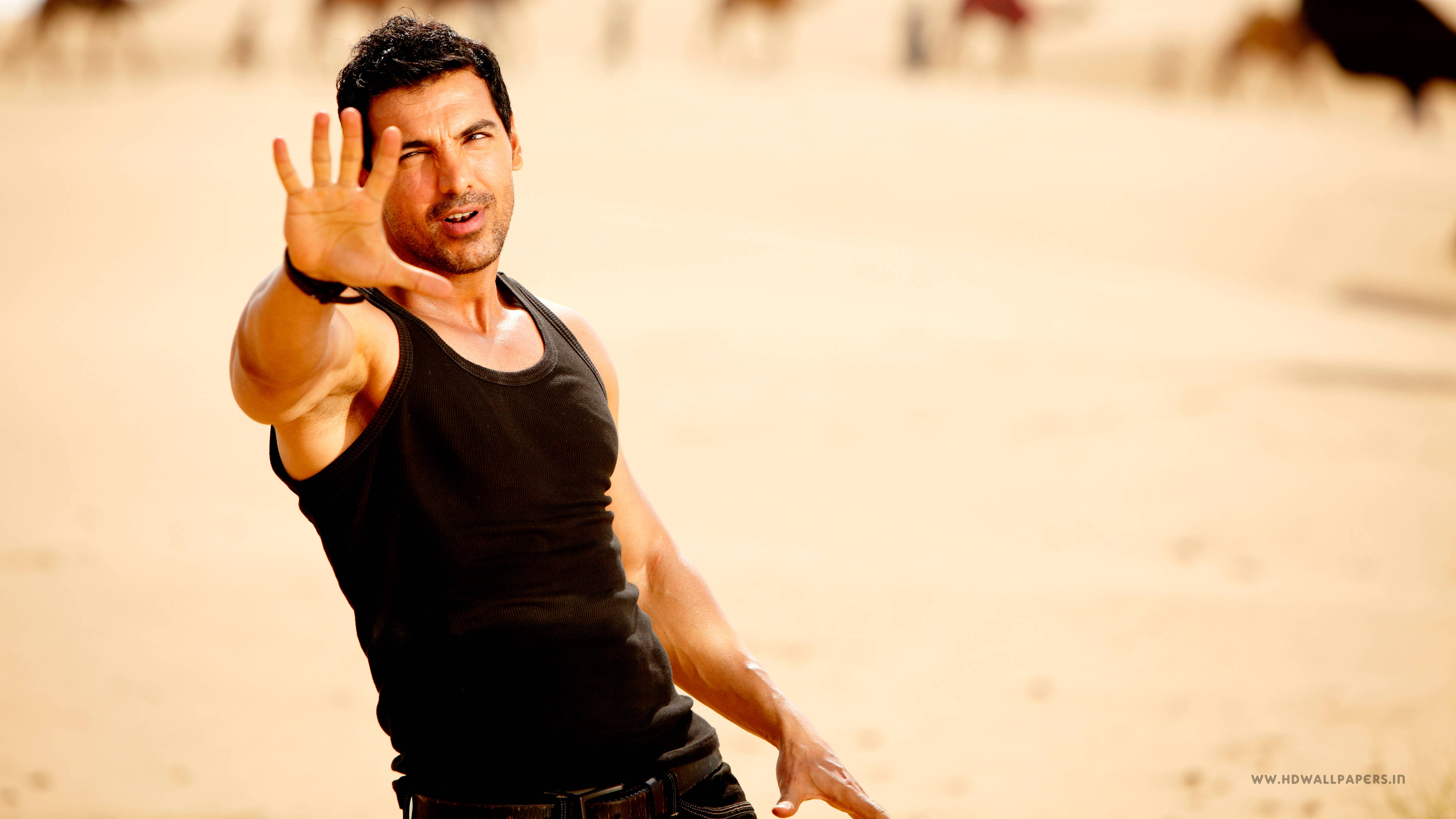 John Abraham, black tank top, sandy background, 4K Desktop Wallpaper