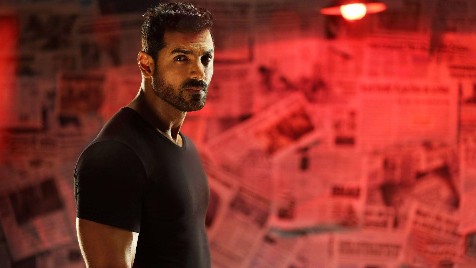 John Abraham, black shirt, red-lit room, Full HD Desktop Wallpaper