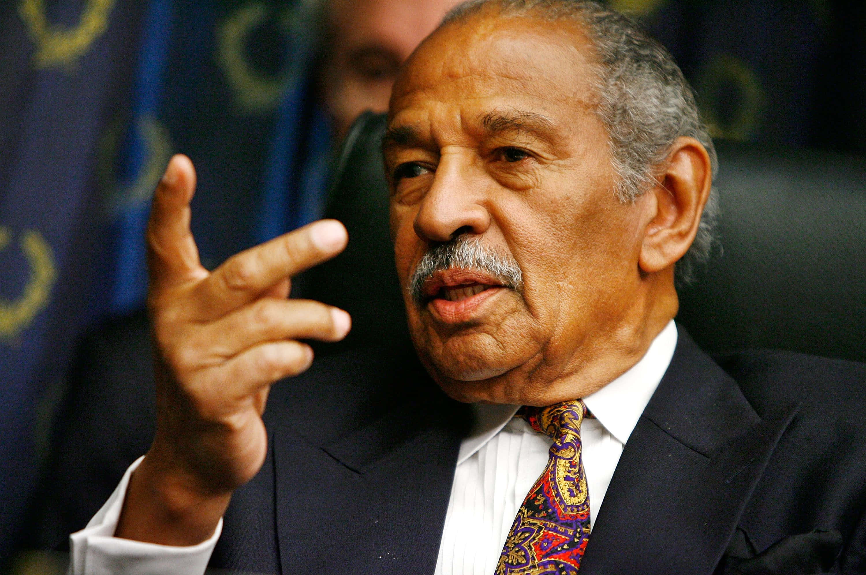 John Conyers, dark suit, colorful paisley tie, 2K Desktop Wallpaper
