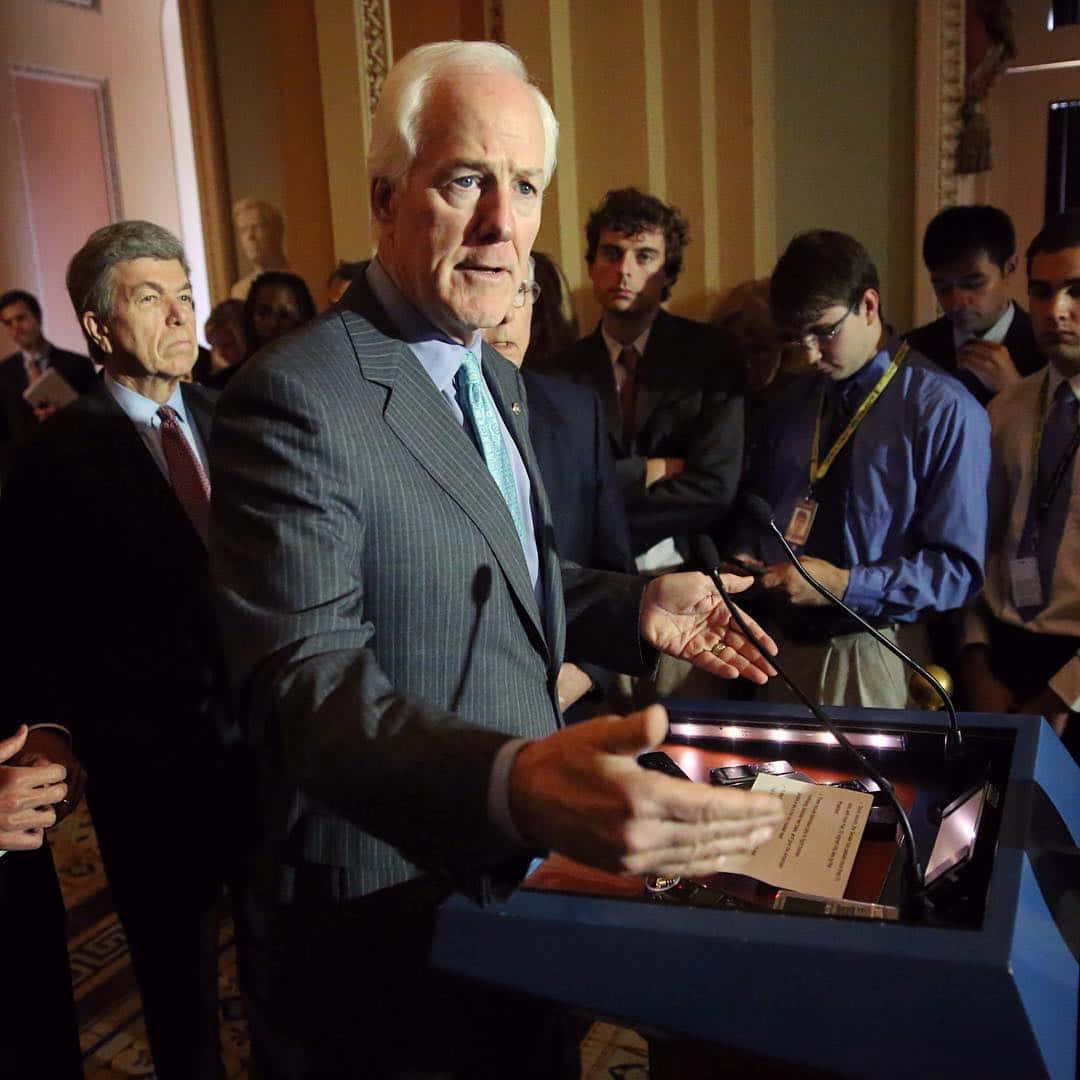 John Cornyn, pinstripe suit, podium, SD Desktop Wallpaper