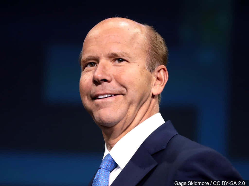 John Delaney, dark suit, blue patterned tie, SD Desktop Wallpaper