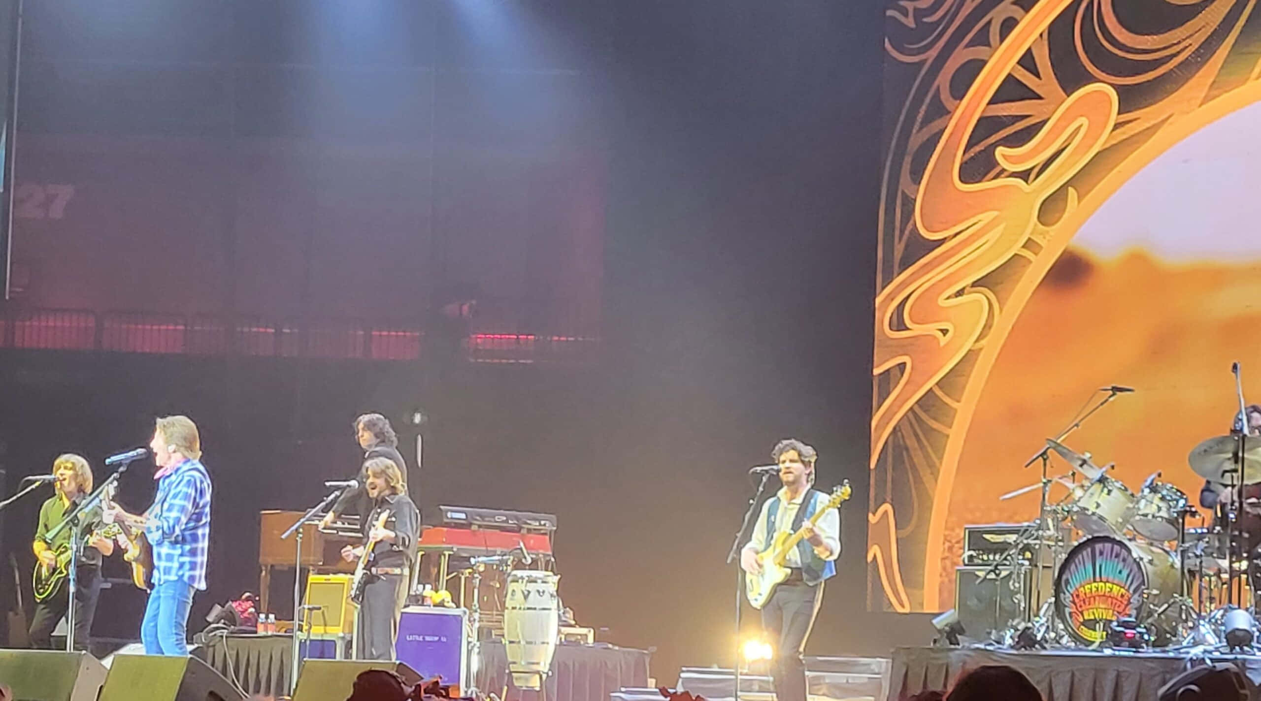 John Fogerty, live band, dimly lit stage, 2K Desktop Wallpaper