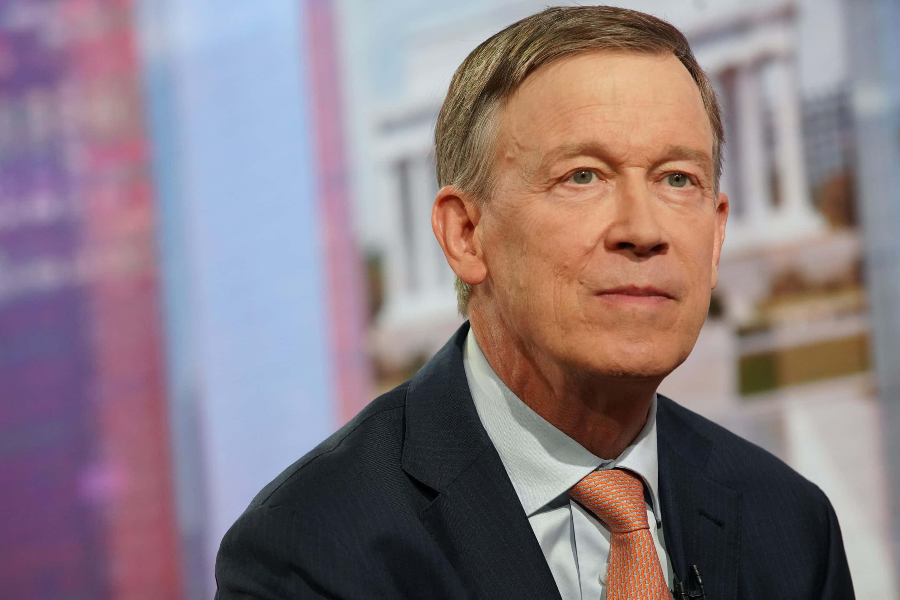 John Hickenlooper, dark suit, orange tie, 2K Desktop Wallpaper