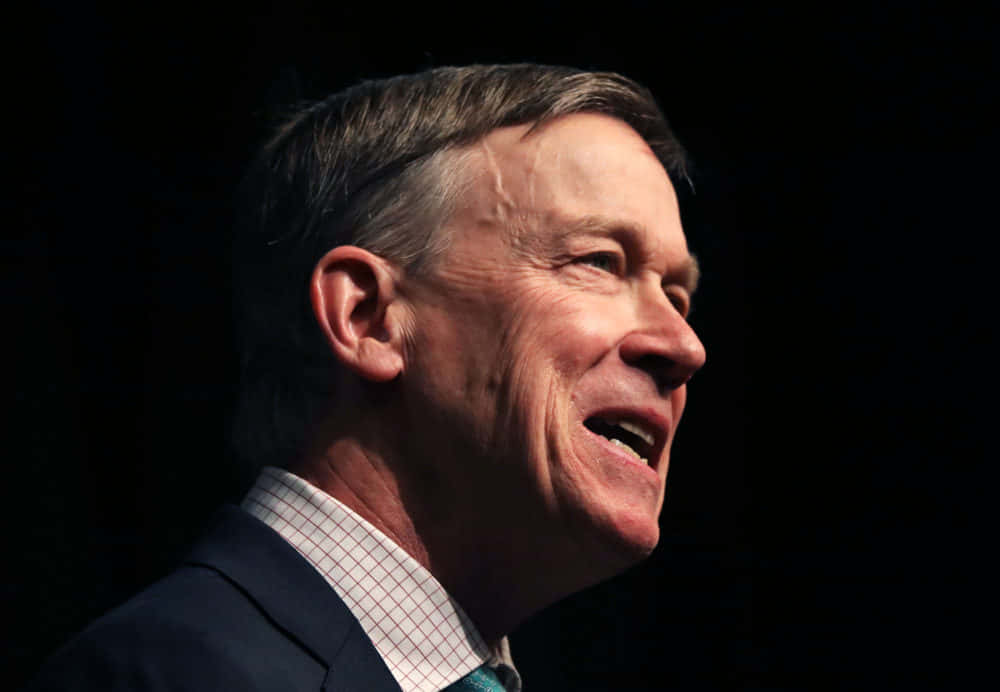 John Hickenlooper, black backdrop, suit, SD Desktop Wallpaper