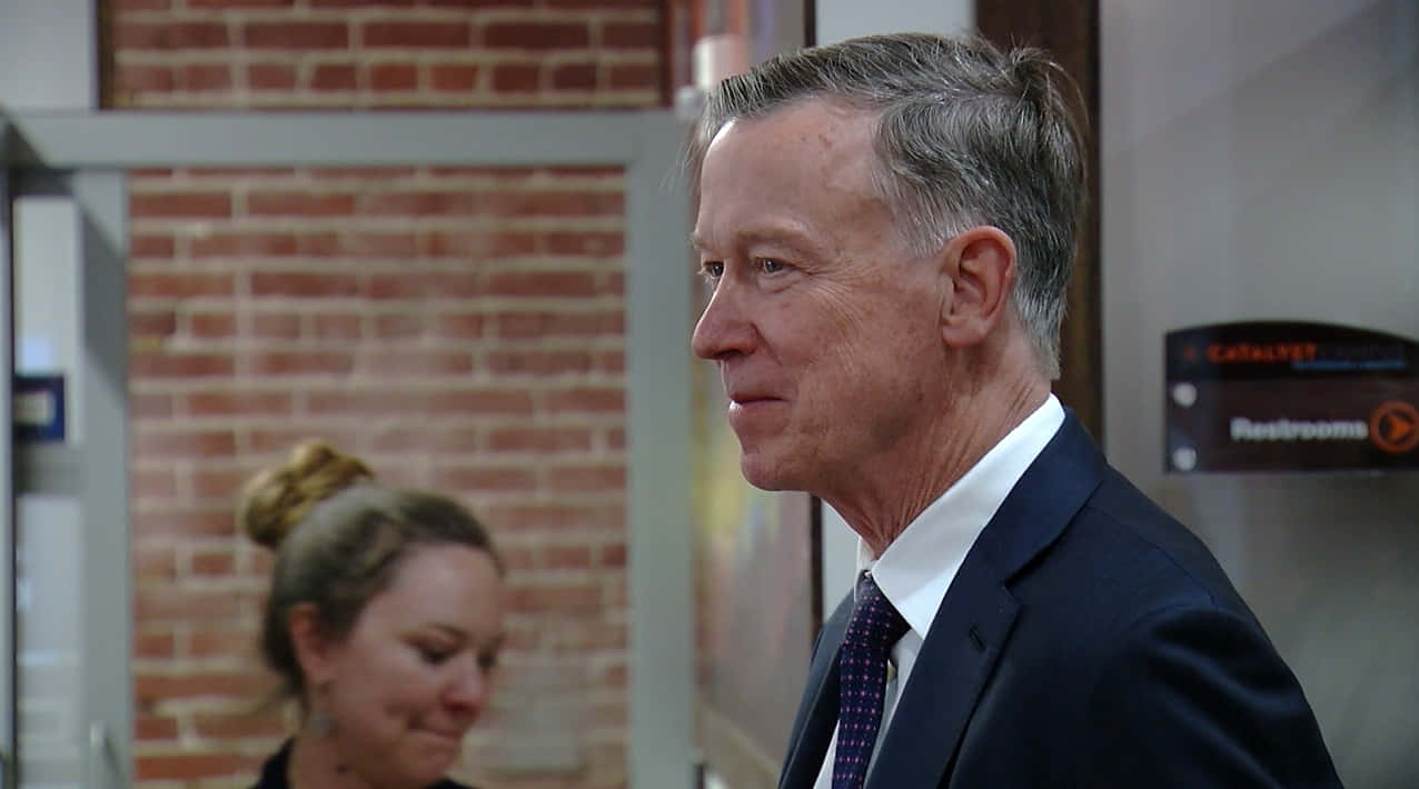 John Hickenlooper, dark blue suit, brick wall, SD Desktop Wallpaper