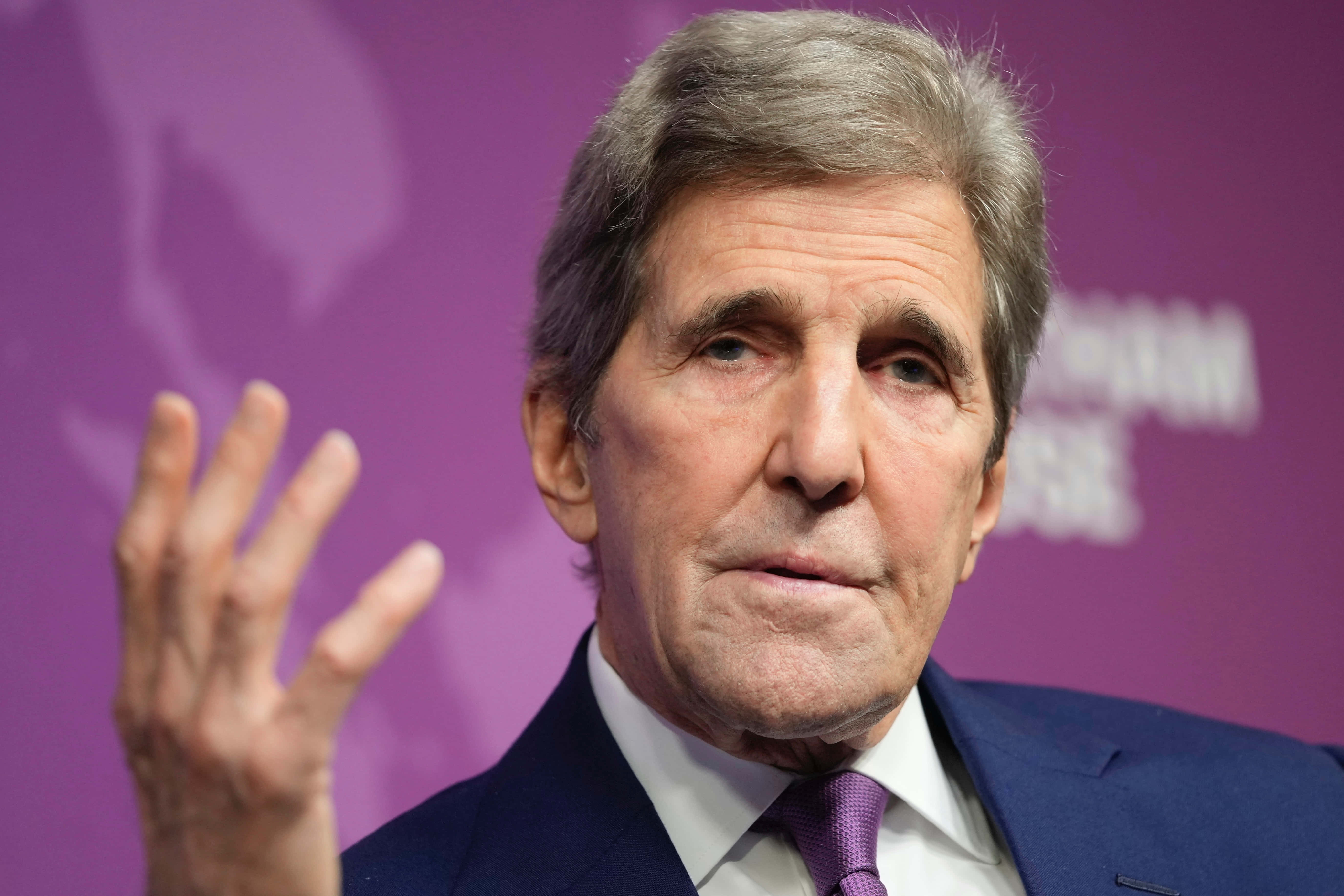 John Kerry, one hand up, purple backdrop, 5K Desktop Wallpaper