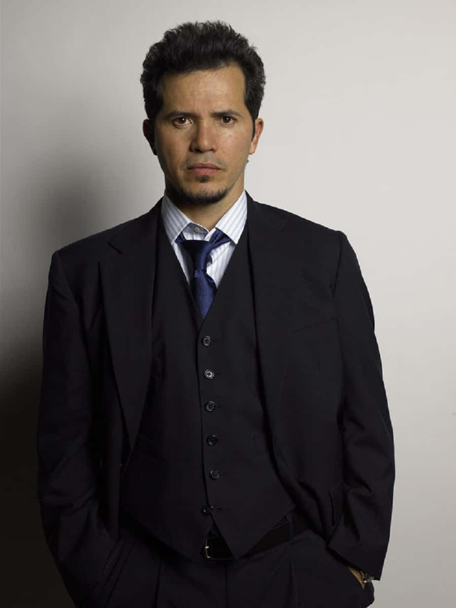 John Leguizamo, dark three-piece suit, plain gray background, SD Phone Wallpaper