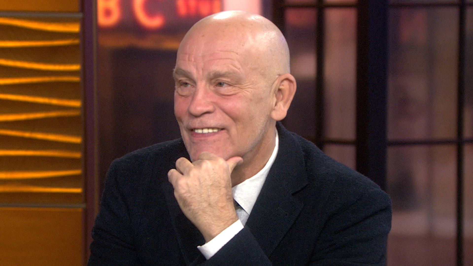 John Malkovich, TV studio set, dark suit, Full HD Desktop Wallpaper