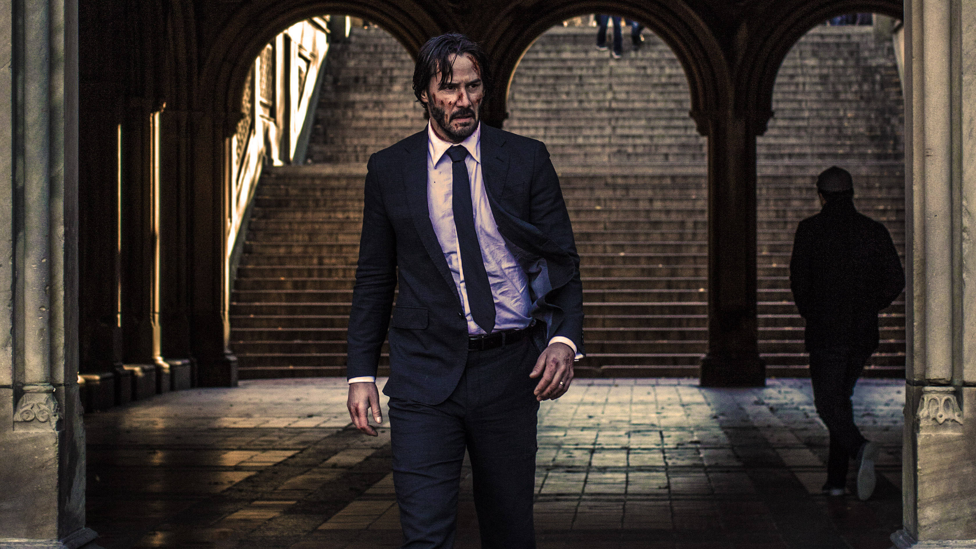 John Wick, dark suit, arched stone corridor, 2K Desktop Wallpaper