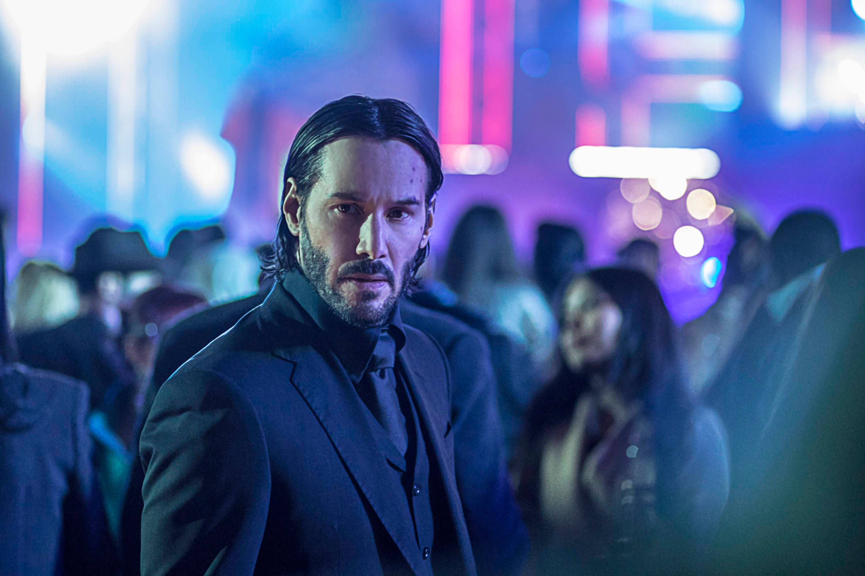 John Wick, neon-lit crowd, vibrant blue pink lights, 2K Desktop Wallpaper