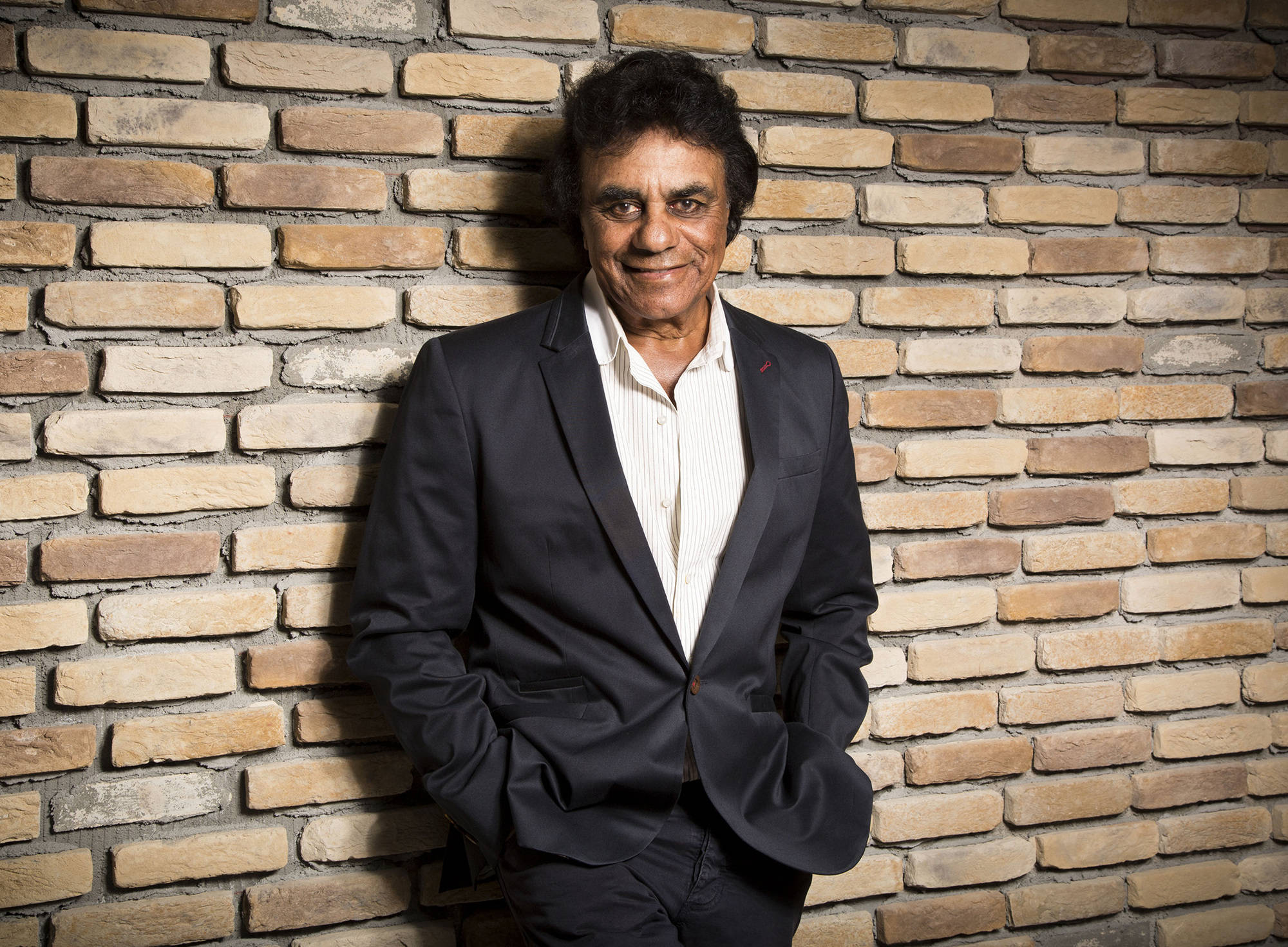 Johnny Mathis, dark suit, textured brick wall, Full HD Desktop Wallpaper