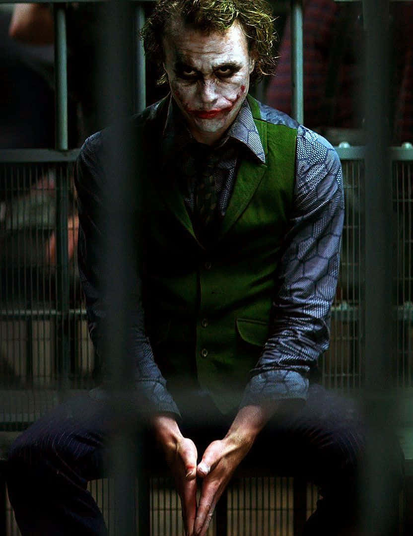 Joker, prison bars, dimly lit cell, SD Phone Wallpaper