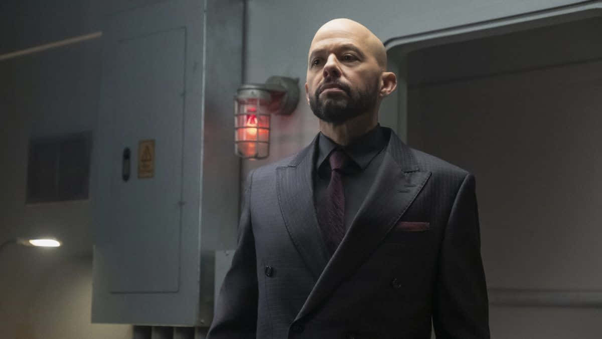 Jon Cryer, dark suit, dimly lit industrial hallway, SD Desktop Wallpaper