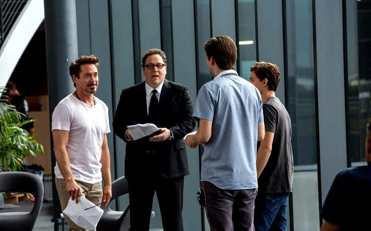 Jon Favreau, modern glass-walled office space, potted plants, SD Desktop Wallpaper