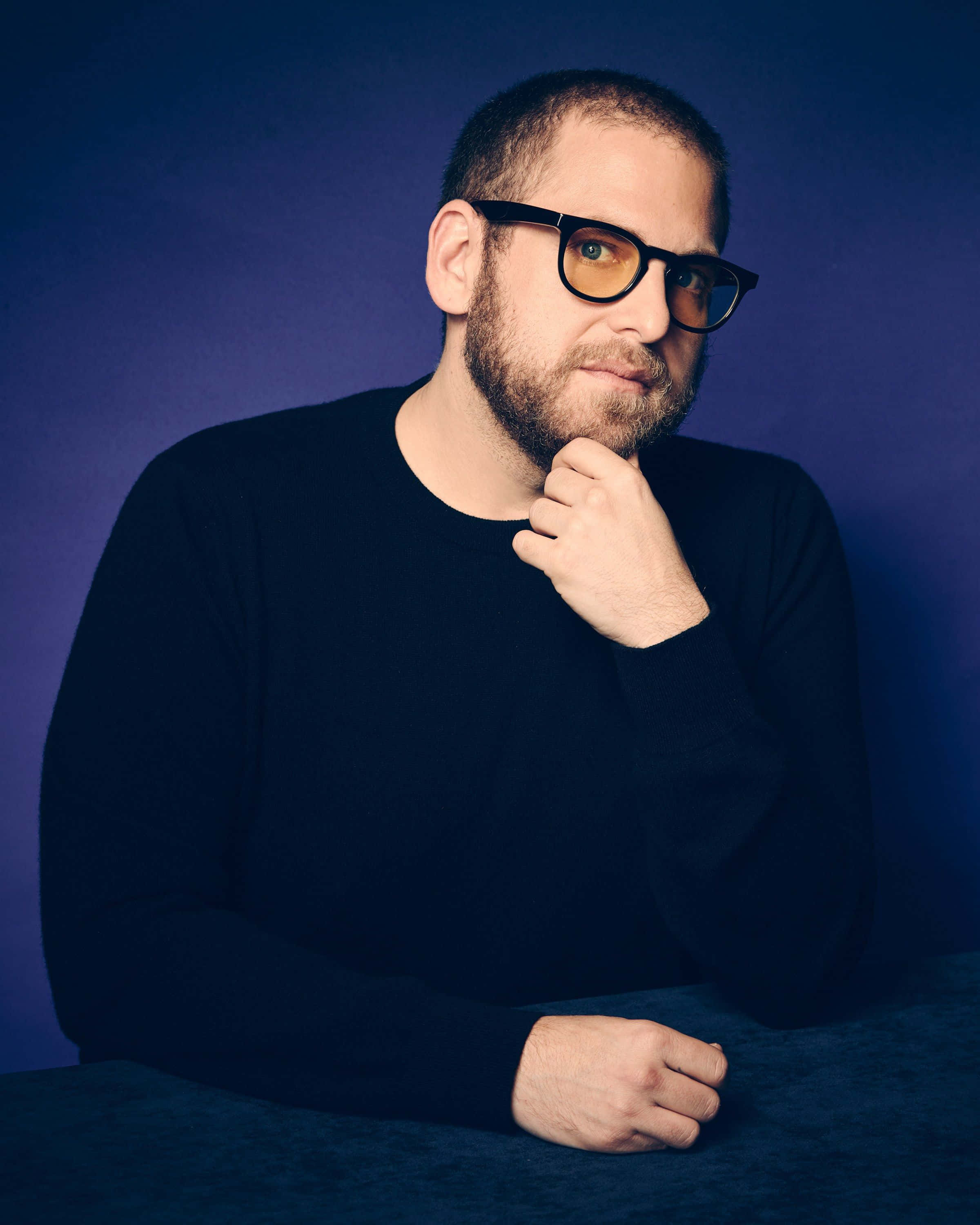 Jonah Hill, deep blue studio backdrop, glasses, 2K Phone Wallpaper