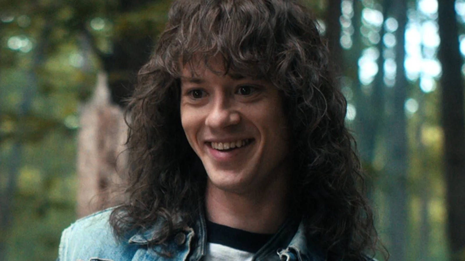 Joseph Quinn, long curly hair, sunlit forest, HD Desktop Wallpaper