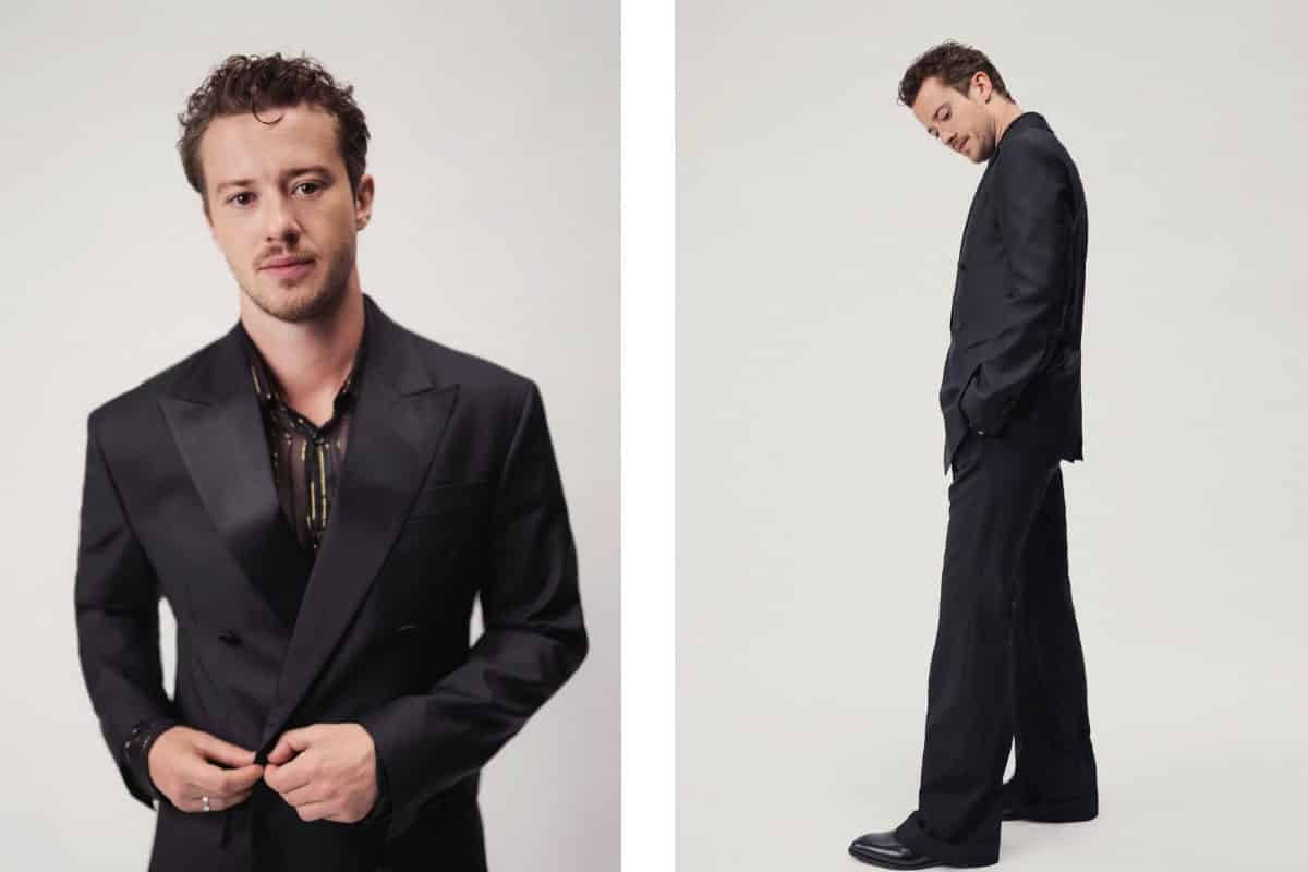 Joseph Quinn, sleek black suit, minimalist studio setting, SD Desktop Wallpaper
