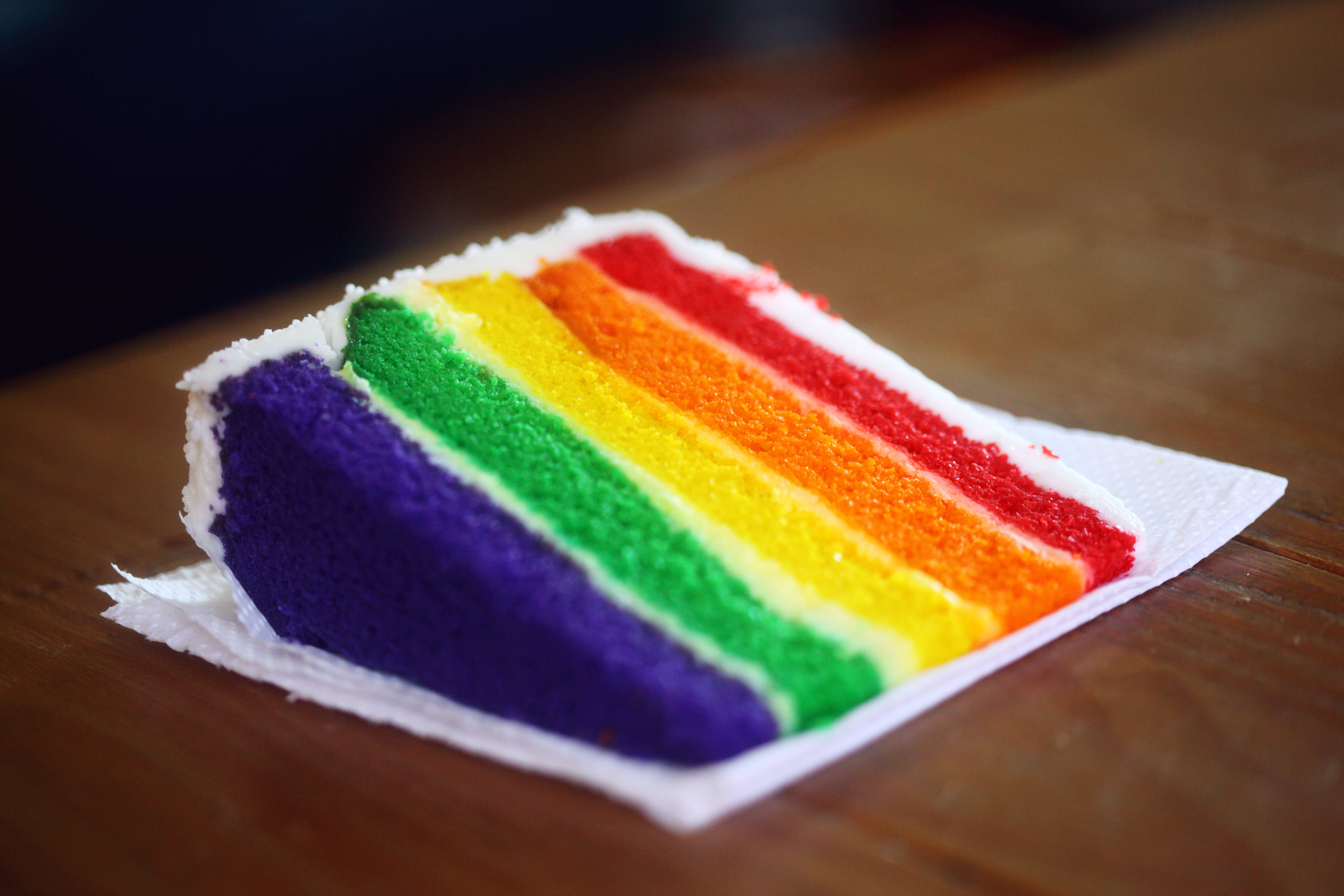 rainbow-layered cake, white napkin, wooden table, 5K Desktop Wallpaper