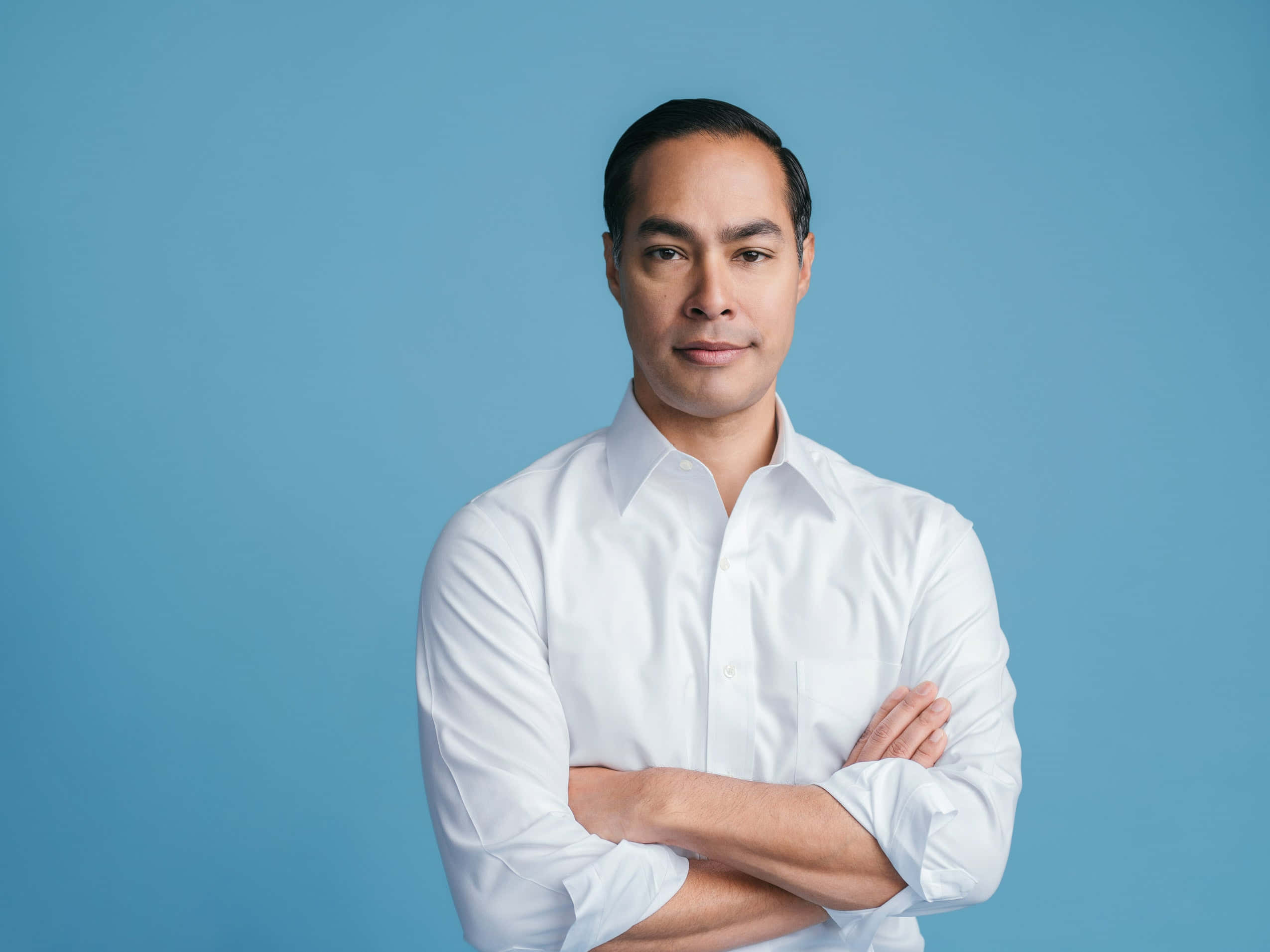 Julian Castro, crisp white shirt, solid blue studio background, Full HD Desktop Wallpaper