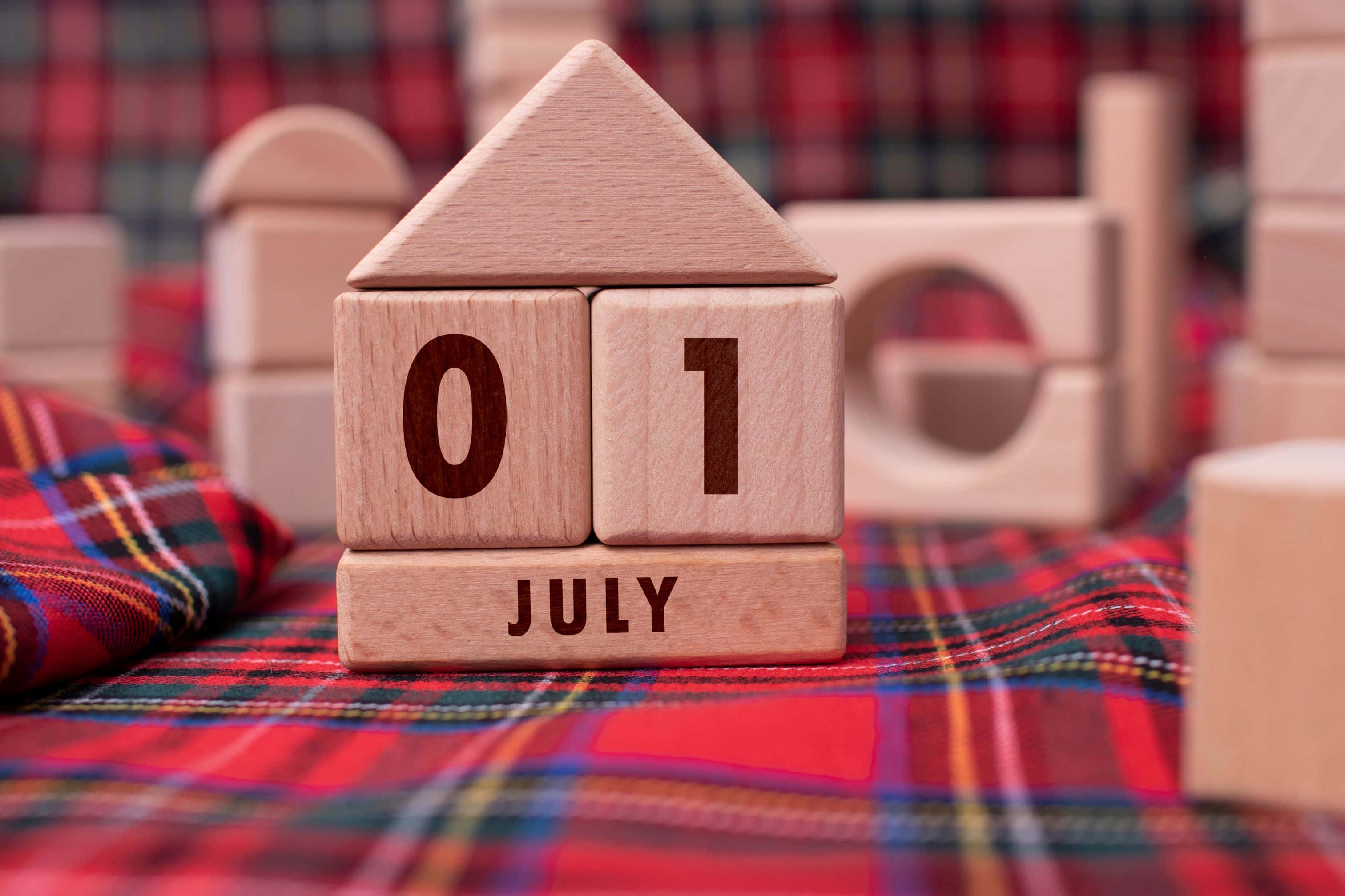 July 1st, wooden house-shaped calendar block, vibrant red plaid fabric, 2K Desktop Wallpaper