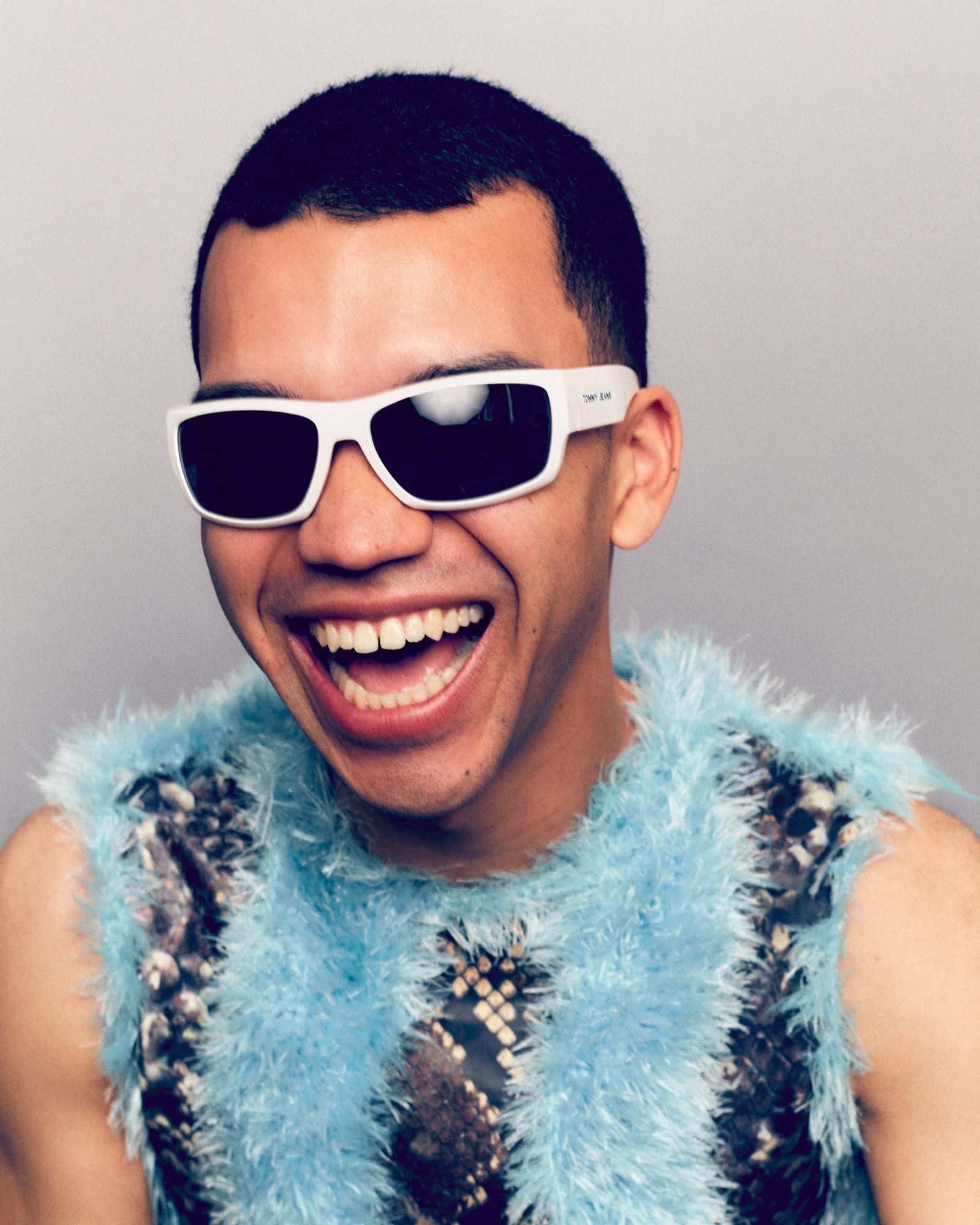Justice Smith, white sunglasses, fluffy blue and black patterned vest, Full HD Phone Wallpaper