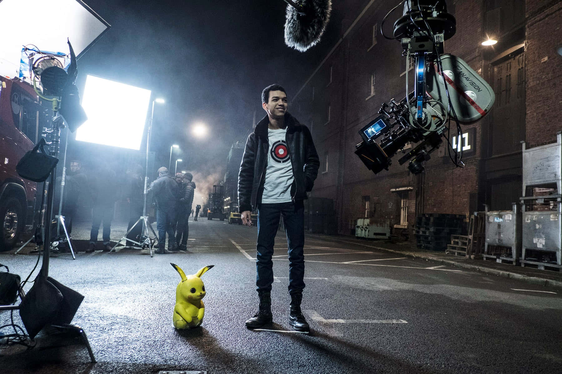 Justice Smith, yellow Pikachu puppet, nighttime film set, HD Desktop Wallpaper