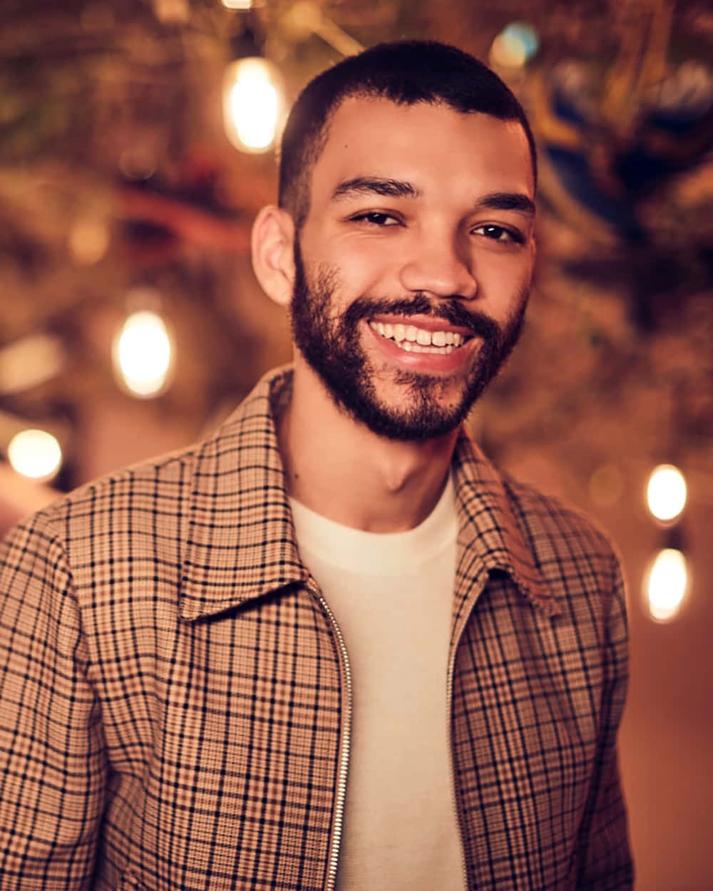Justice Smith, plaid jacket, warm bokeh background, SD Phone Wallpaper