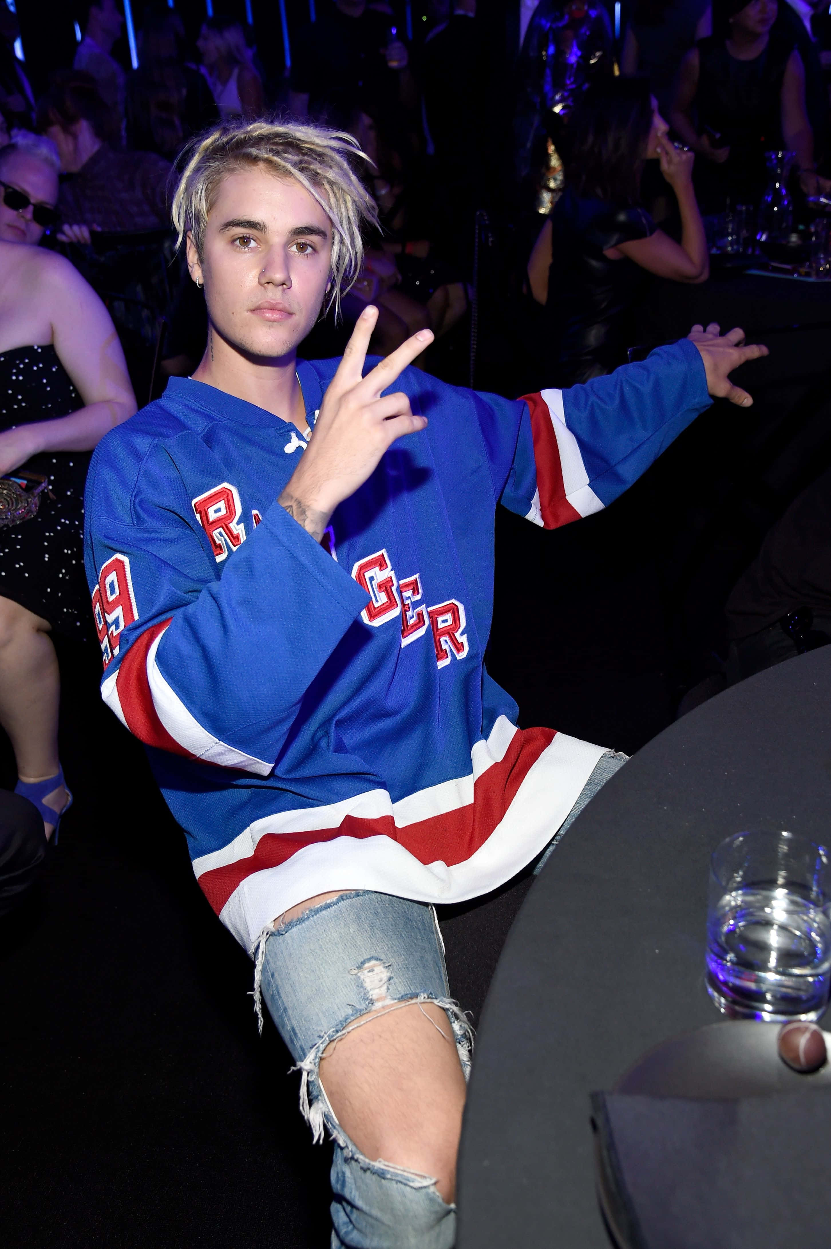 Justin Bieber, blue red and white hockey jersey, dimly lit party, 4K Phone Wallpaper