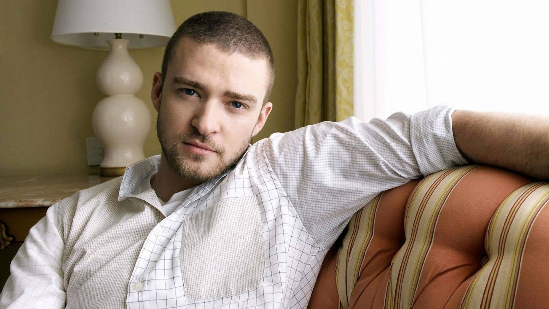 Justin Timberlake, striped tufted sofa, warmly lit room, Full HD Desktop Wallpaper