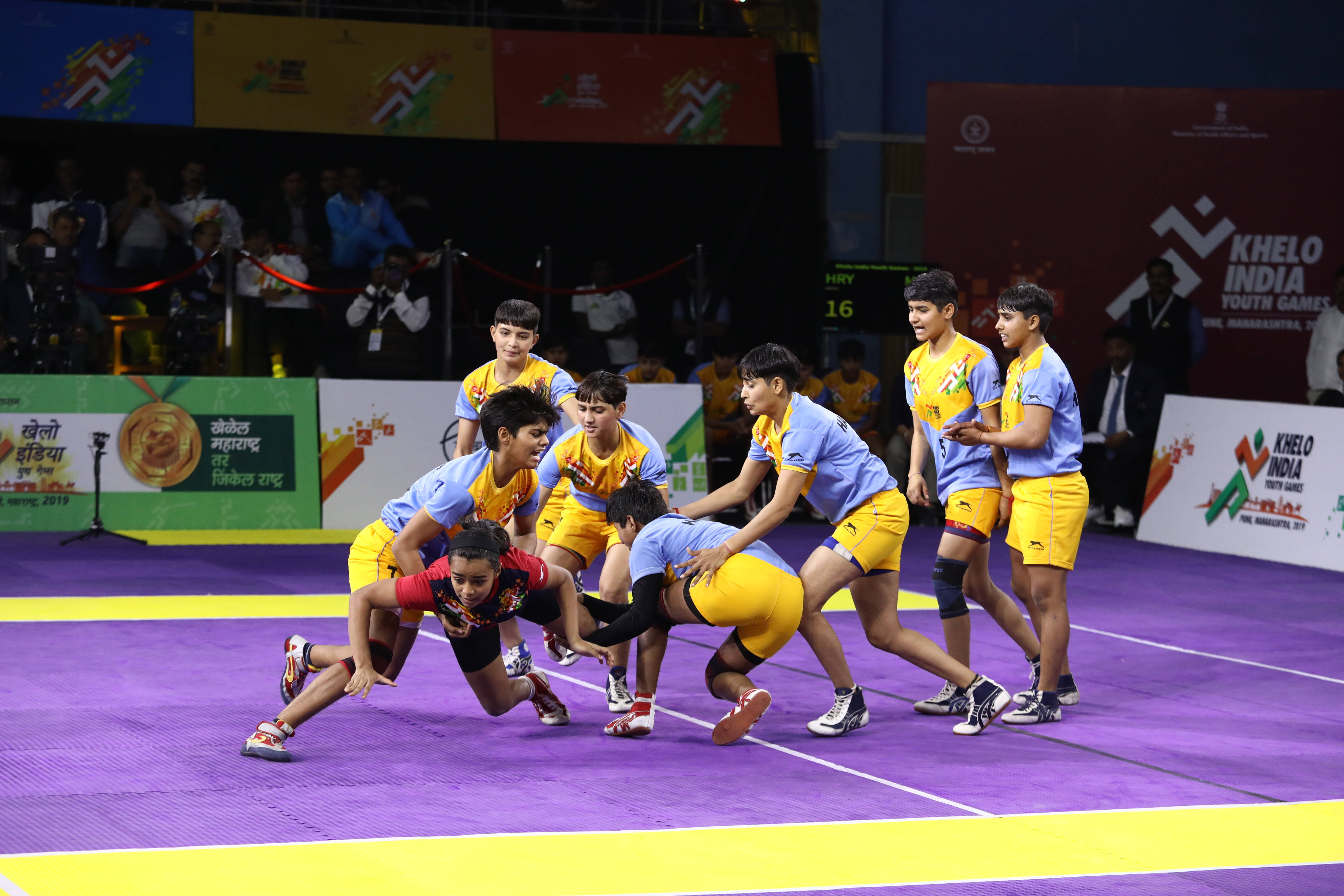 girls kabaddi, blue and yellow uniforms, vibrant purple court, 4K Desktop Wallpaper