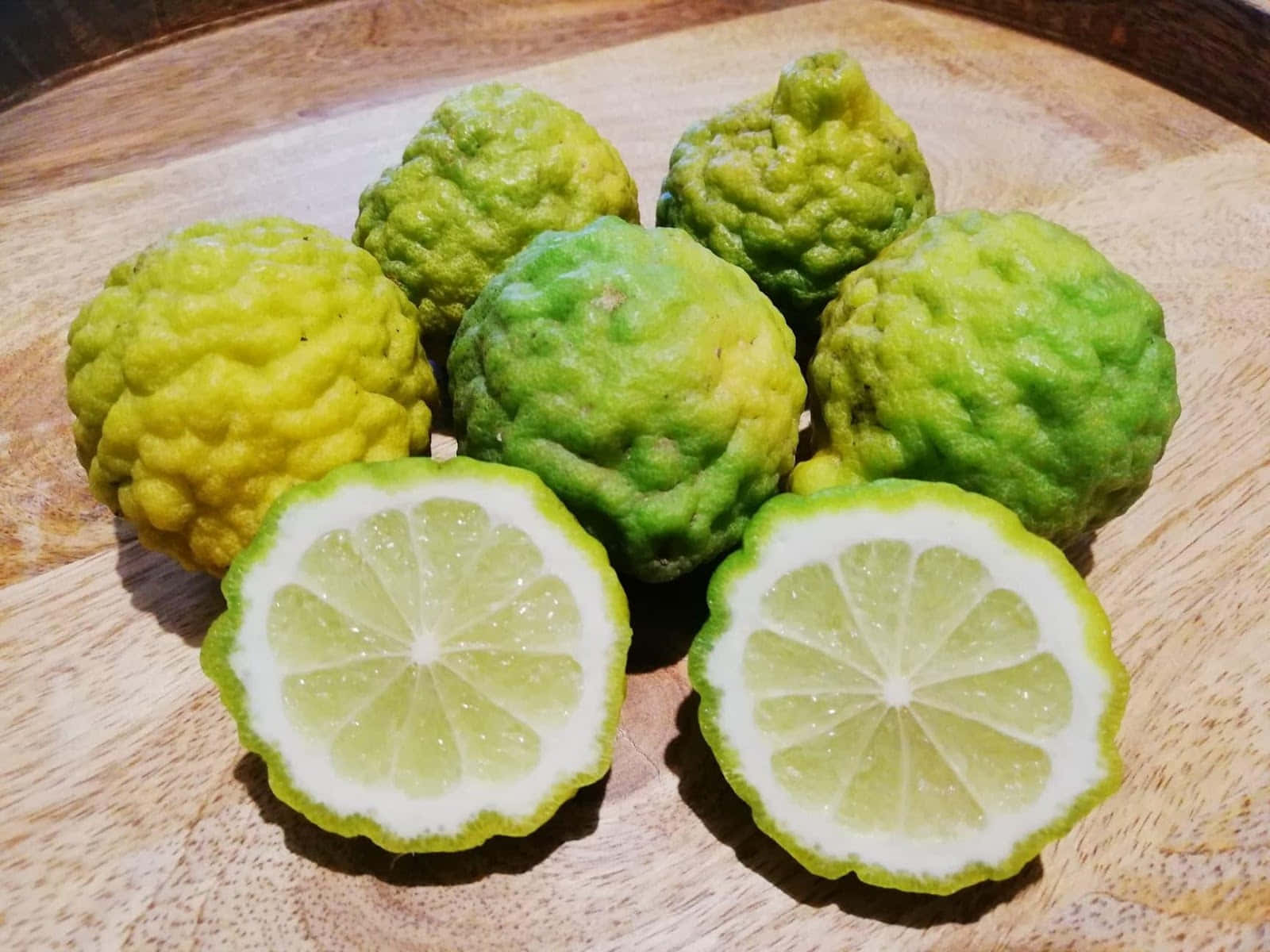 kaffir lime, sliced halves, warm wooden board, HD Desktop Wallpaper