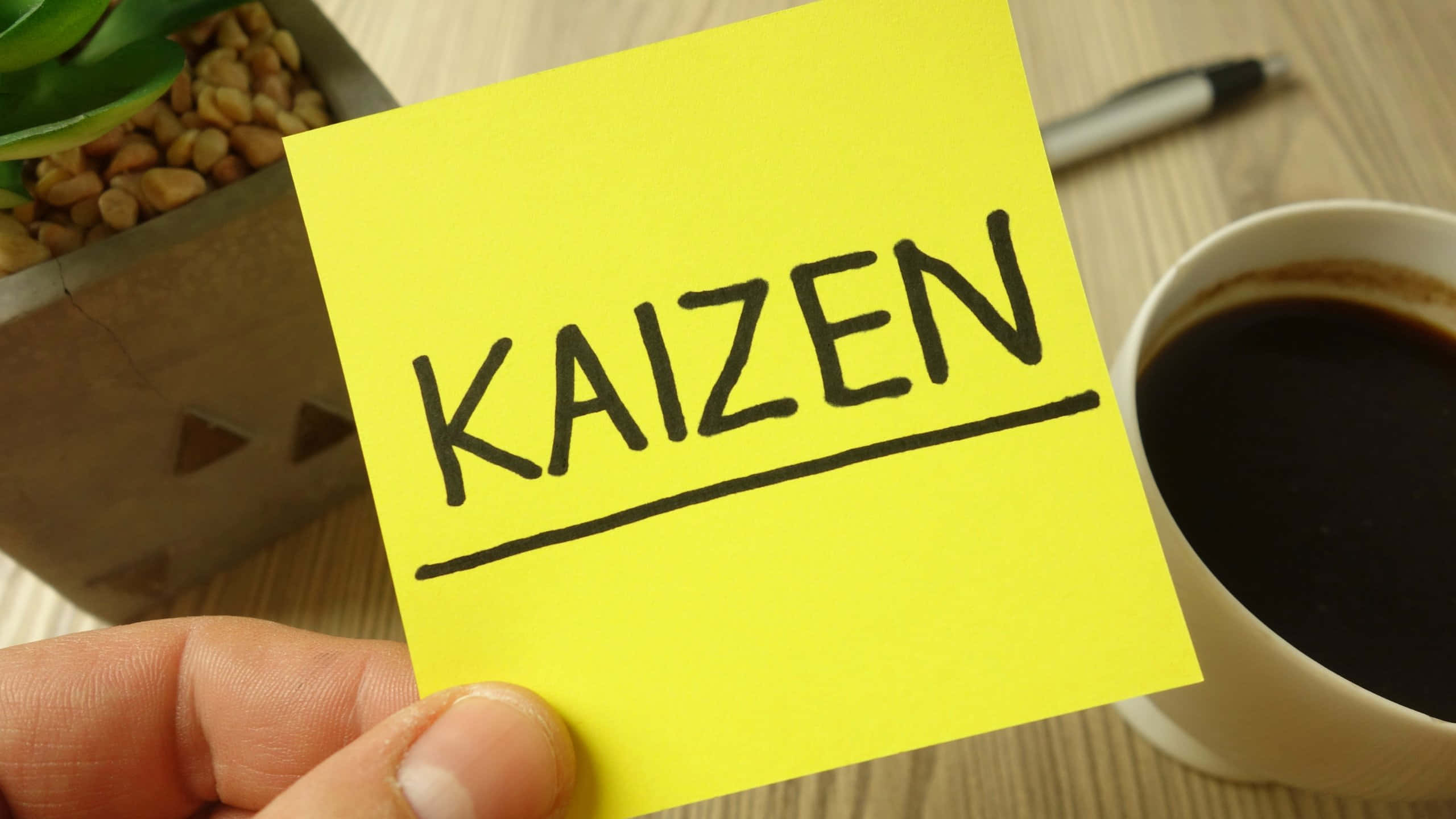 Kaizen, bright yellow sticky note, bold black marker, 2K Desktop Wallpaper