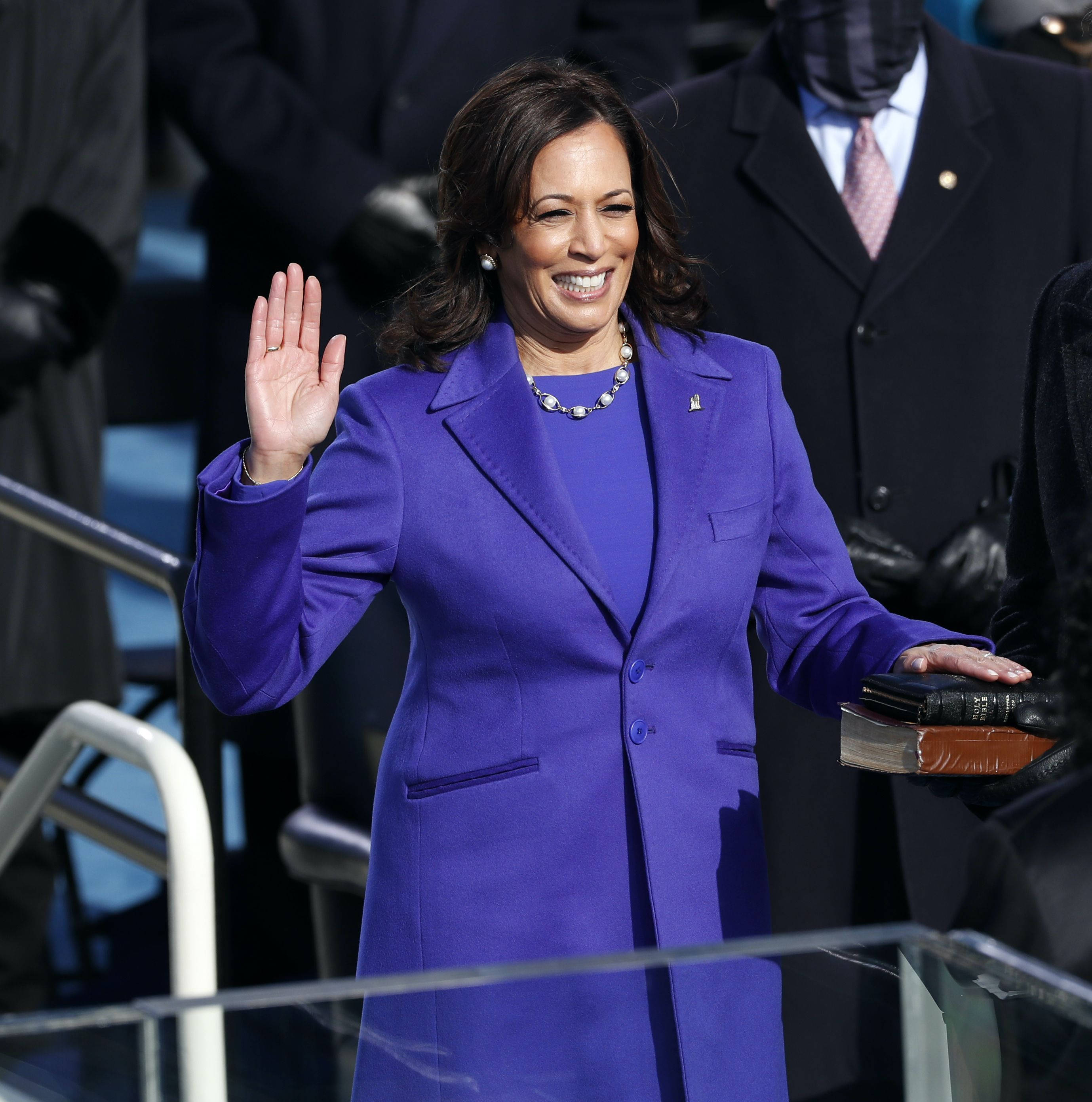 Kamala Harris, vibrant purple suit, Bible, 2K Phone Wallpaper