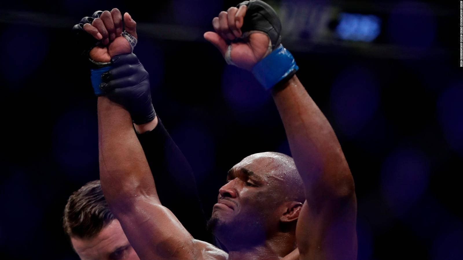 Kamaru Usman, gloved fists, arena lights, HD Desktop Wallpaper