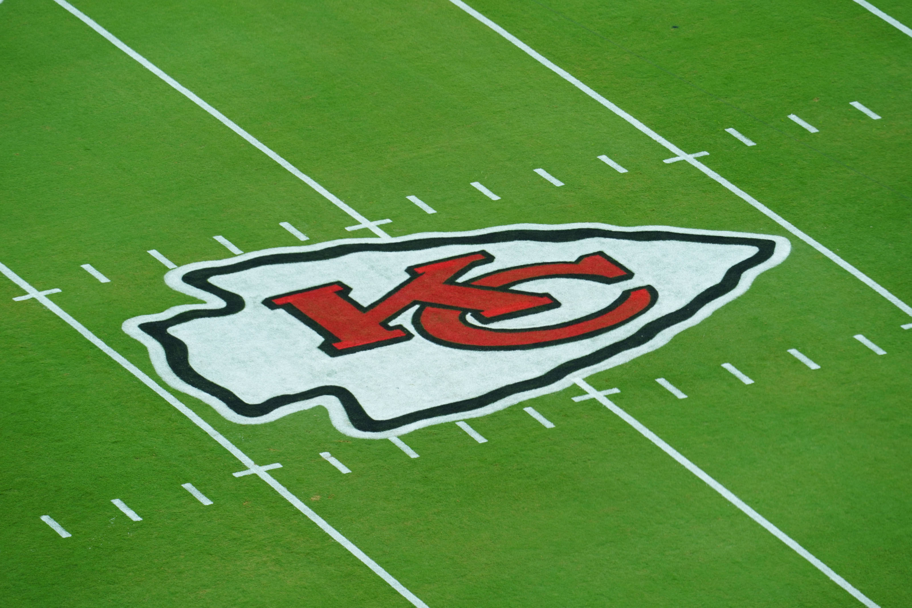 Kansas City Chiefs Logo, vibrant green football field, aerial view, 2K Desktop Wallpaper