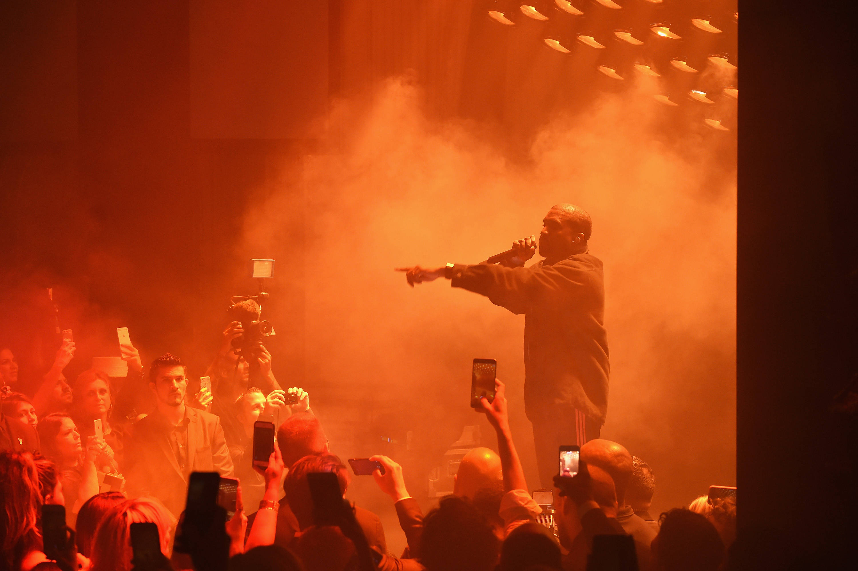 Kanye West Saint Pablo, smoky stage, fiery orange light, 2K Desktop Wallpaper