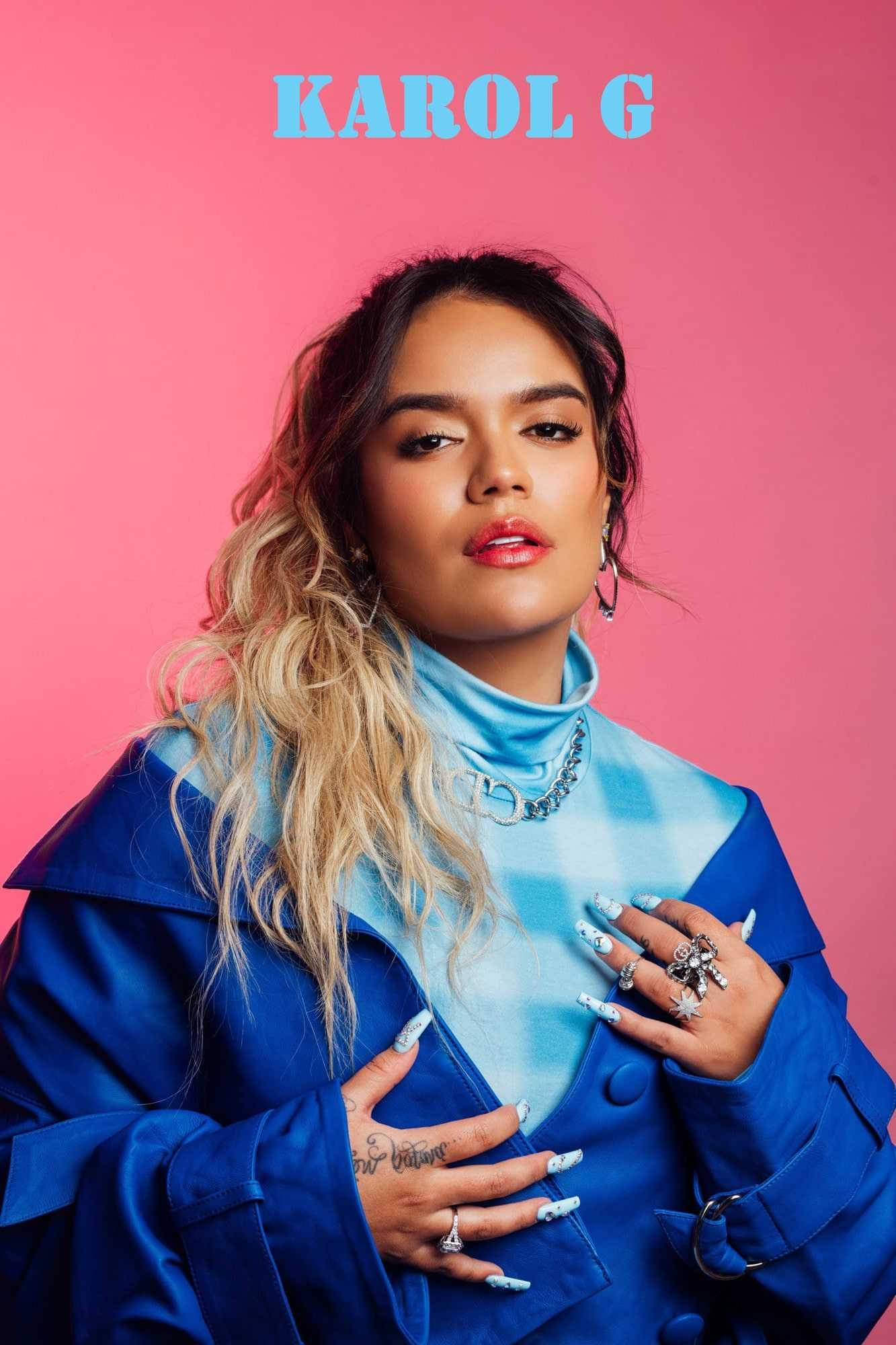 Karol G, bold blue coat, vibrant pink background, Full HD Phone Wallpaper