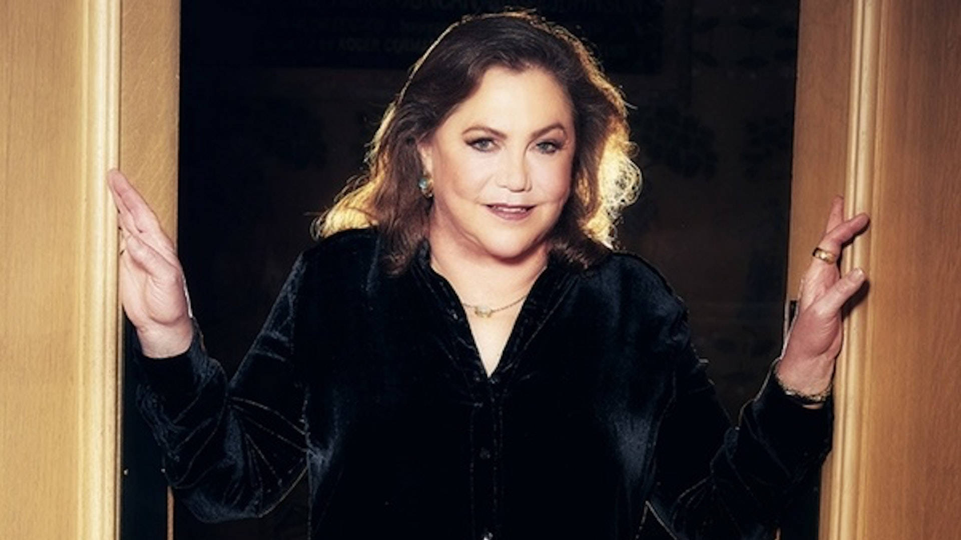 Kathleen Turner, black velvet blouse, wooden doorway, Full HD Desktop Wallpaper