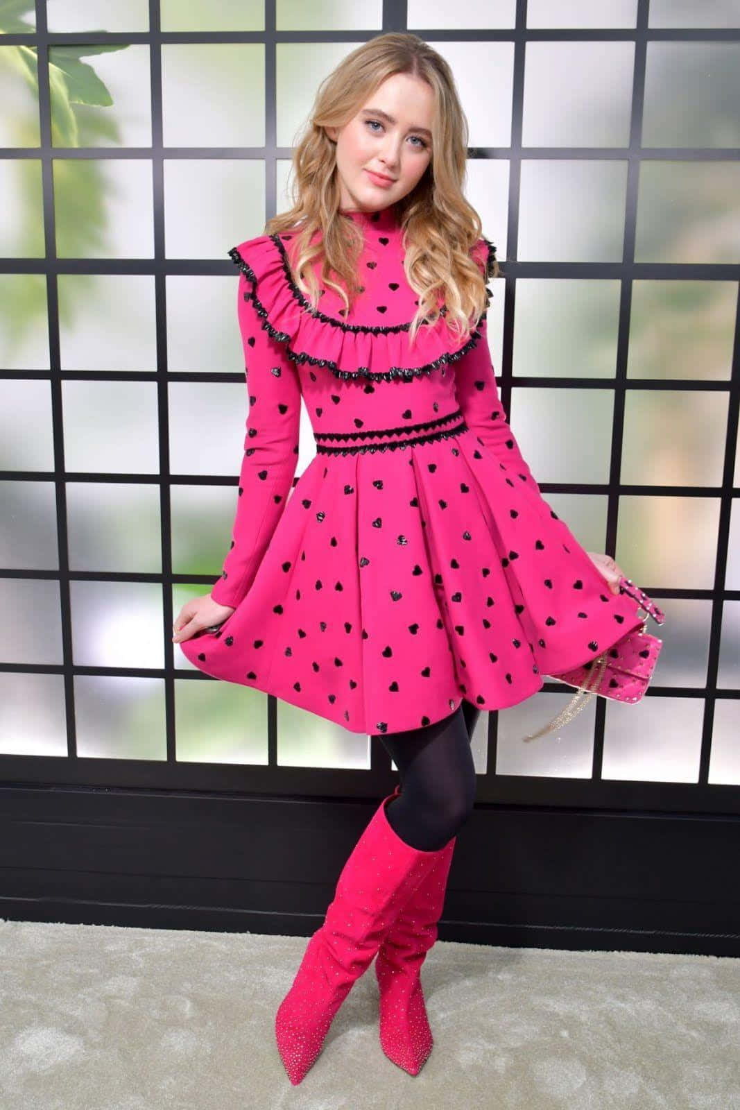 Kathryn Newton, vibrant pink heart-patterned dress, matching boots, HD Phone Wallpaper